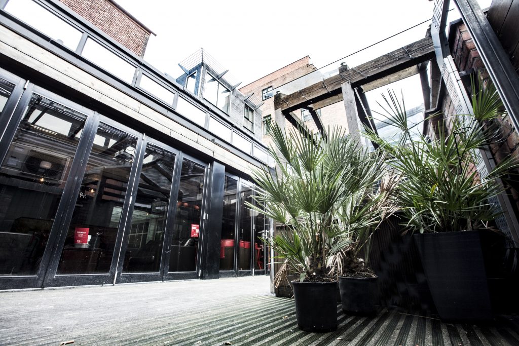 Versatile event space with large windows at Brickhouse Social for corporate and social gatherings.