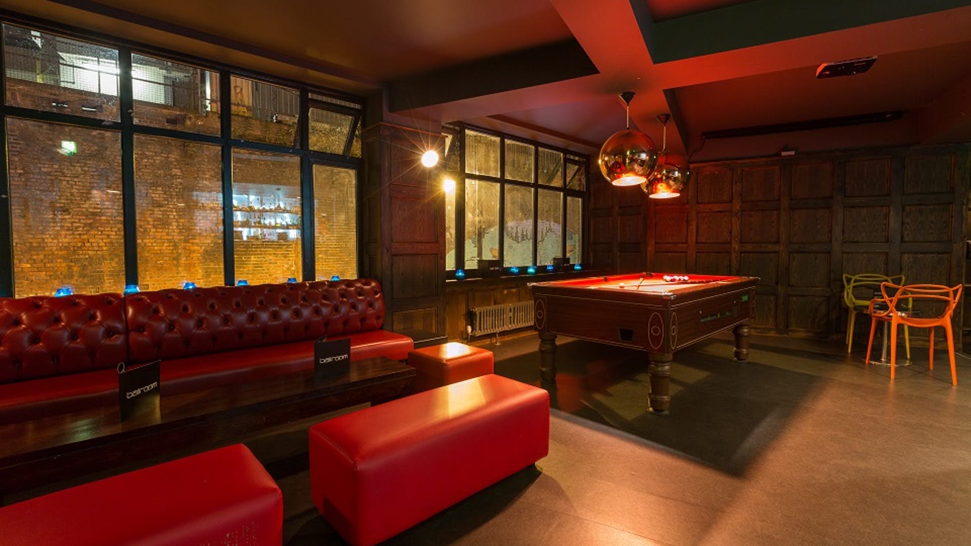 Stylish lounge with plush red seating, ideal for networking events and casual gatherings.