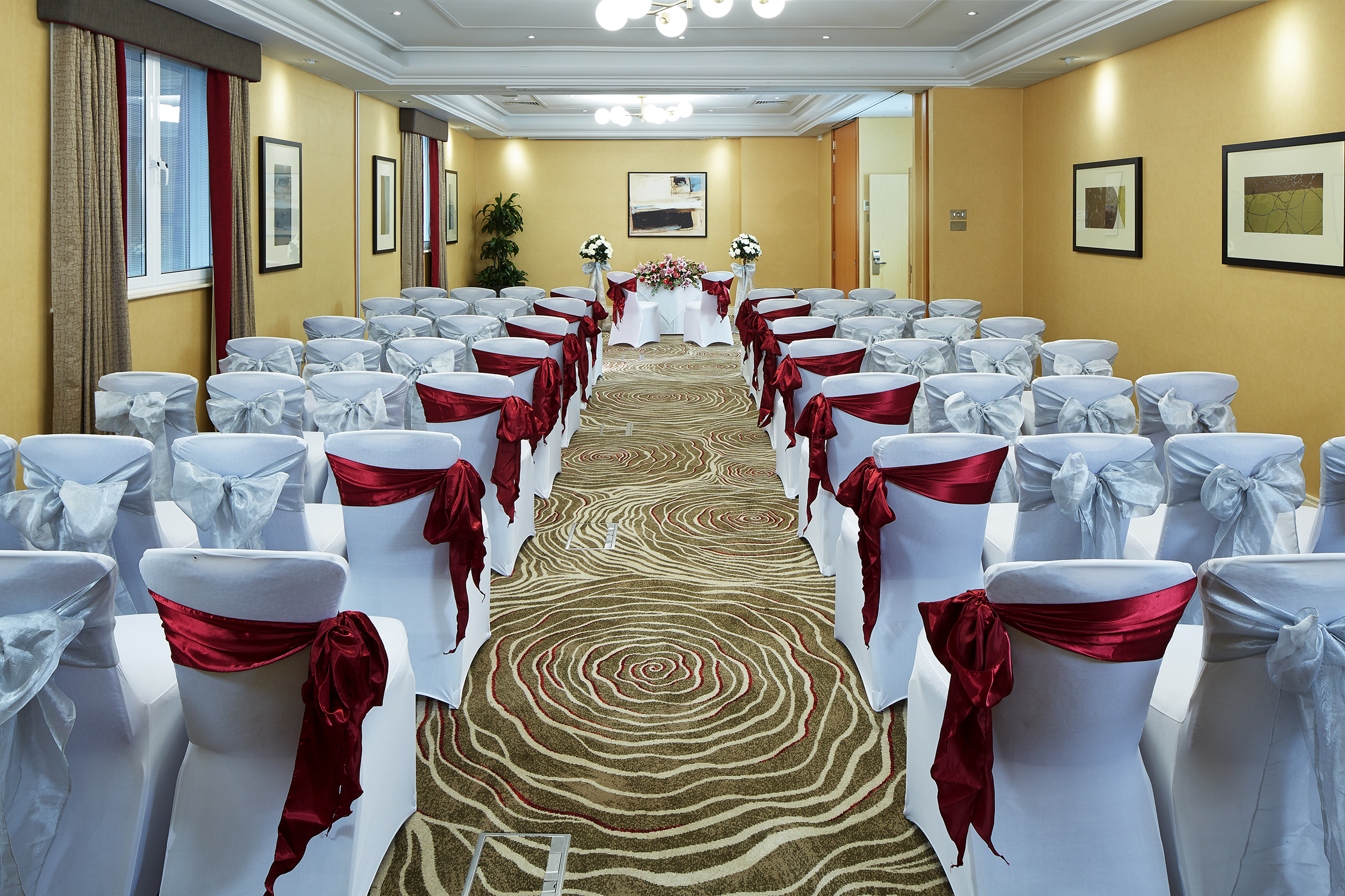 Queens Suite event space with elegant chairs, ideal for corporate meetings and gatherings.