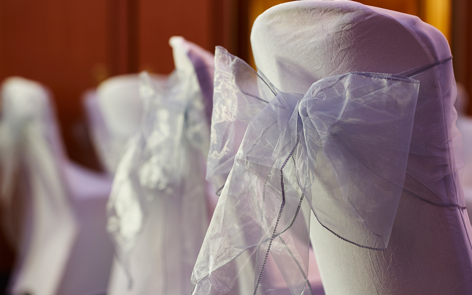 Elegant chair covers with sheer bows in The Rembrandt's Queens Suite for weddings.