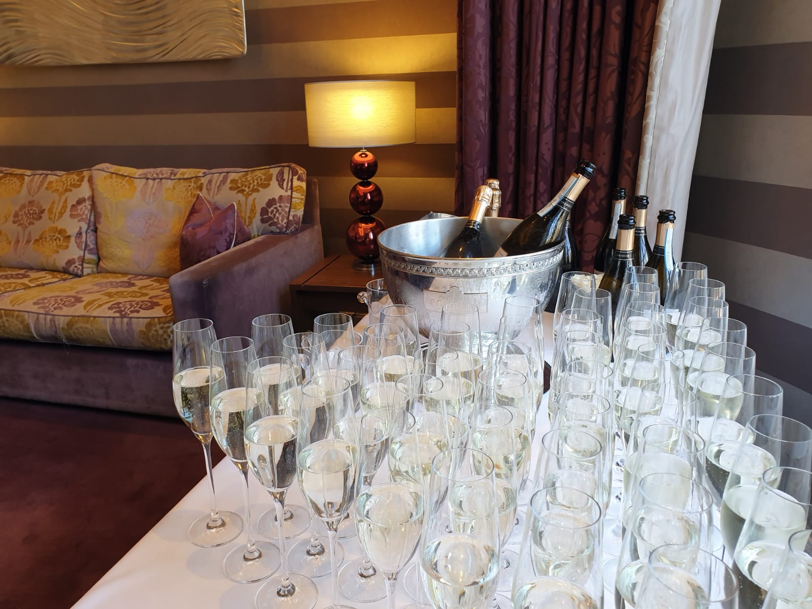 Elegant champagne flutes in The Roseate Library Room for a celebratory event.