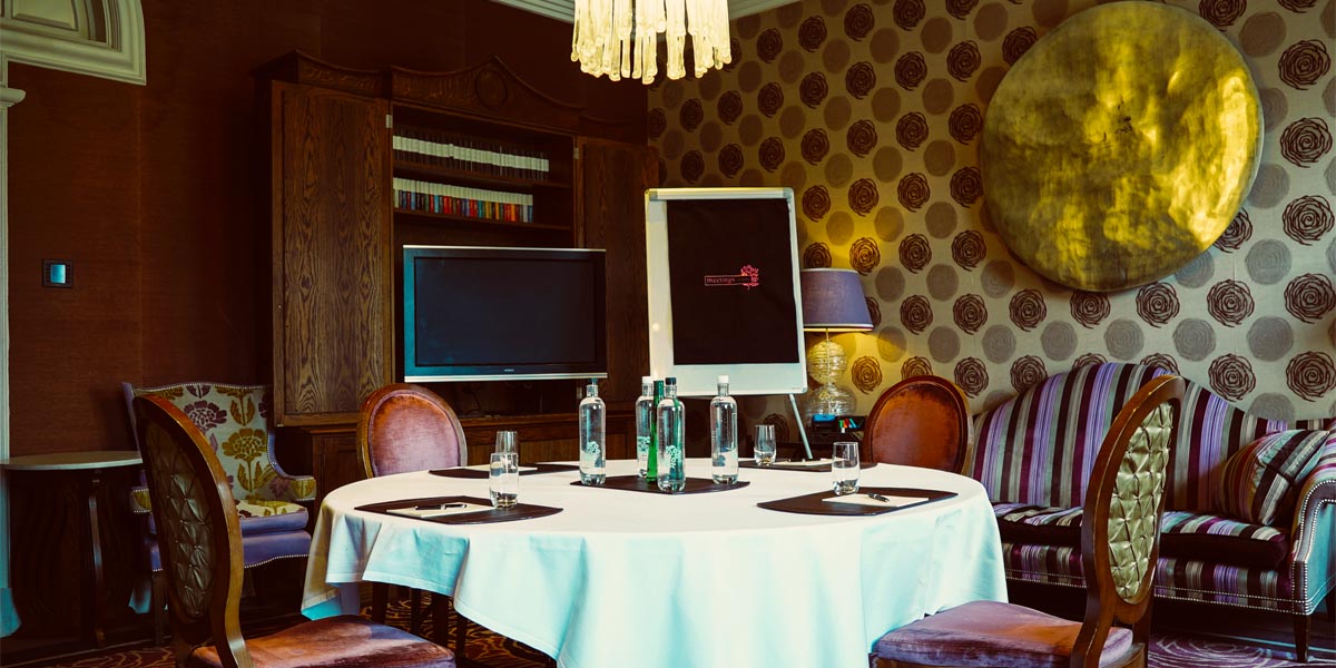Elegant meeting room at The Roseate, Reading with round table setup for intimate gatherings.
