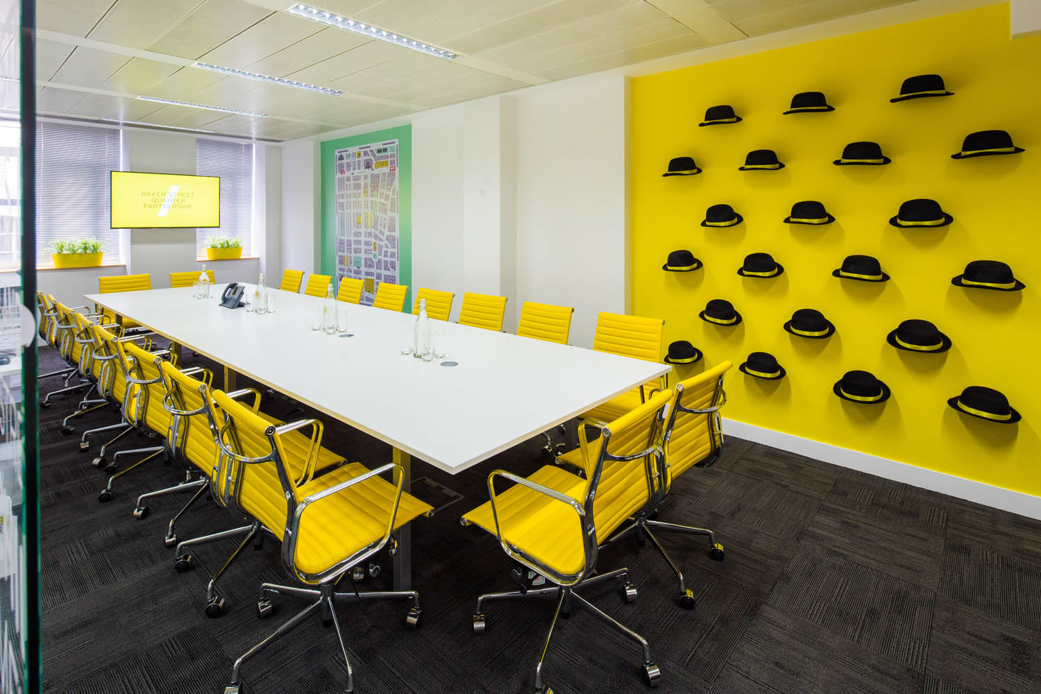 Modern meeting room with yellow accents, ideal for brainstorming and team meetings.