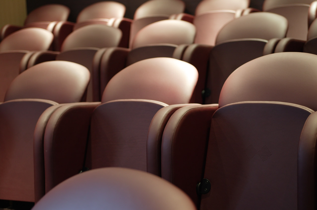 Plush maroon seats in Upstage Mini Cinema, perfect for events and presentations.