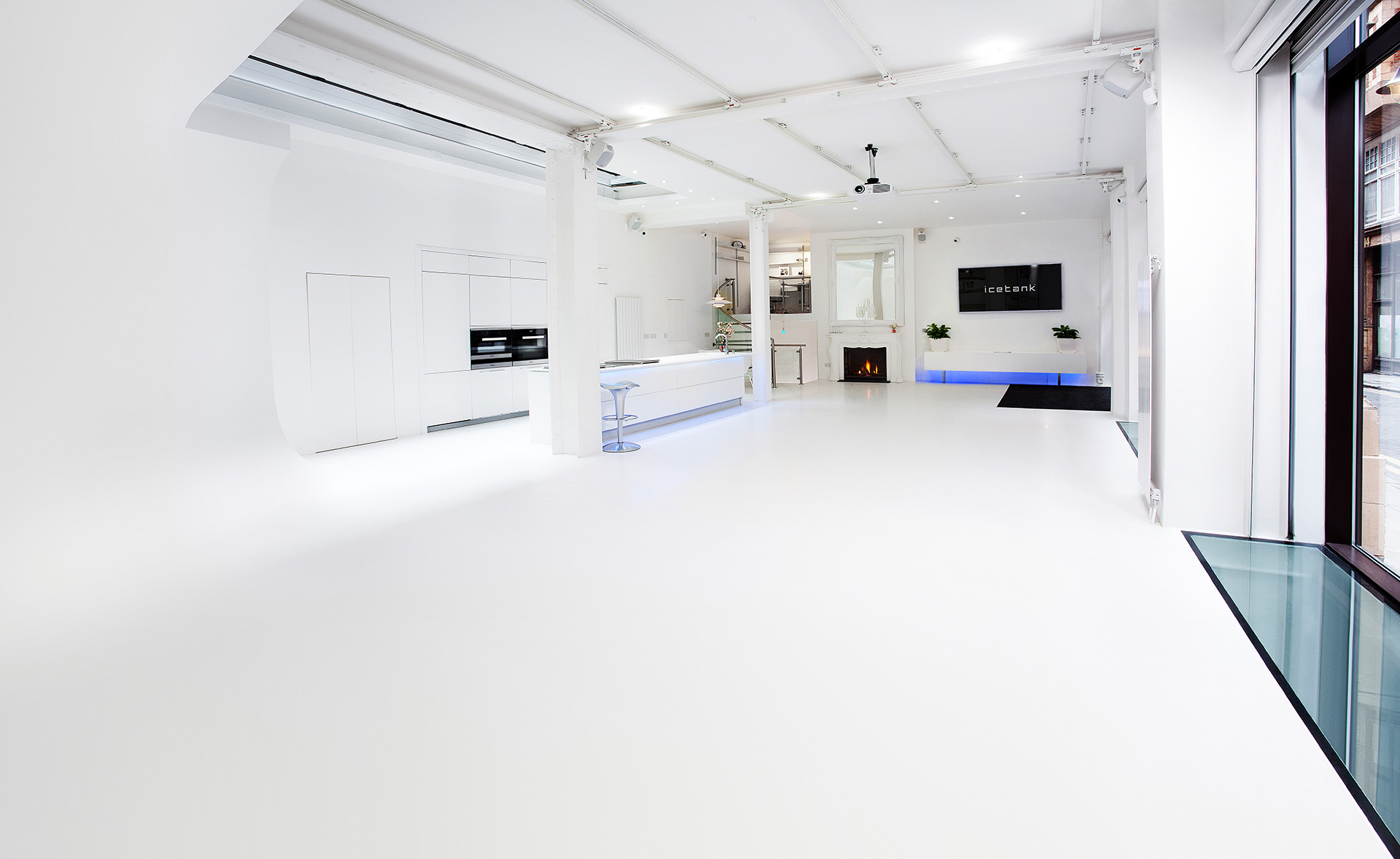 Sleek modern event space with bright white floors, ideal for corporate and social gatherings.