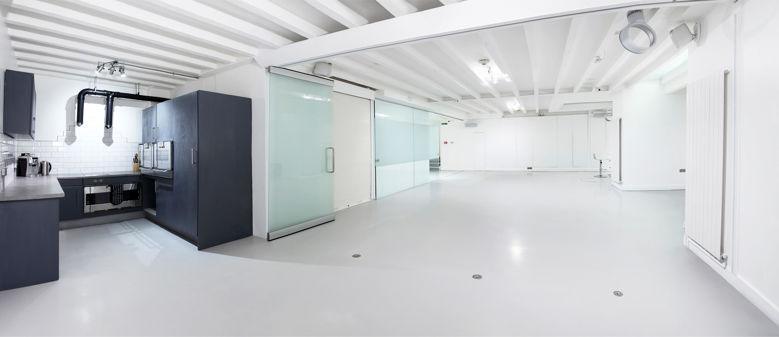 Modern event space with glass partitions, ideal for meetings and gatherings.