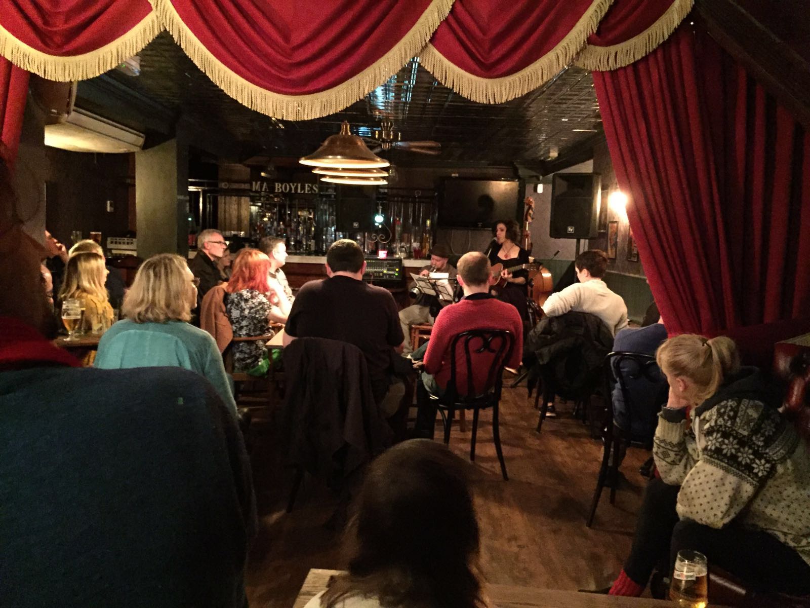 Intimate networking event at Rum and Rumour Kabaret Bar with warm lighting.