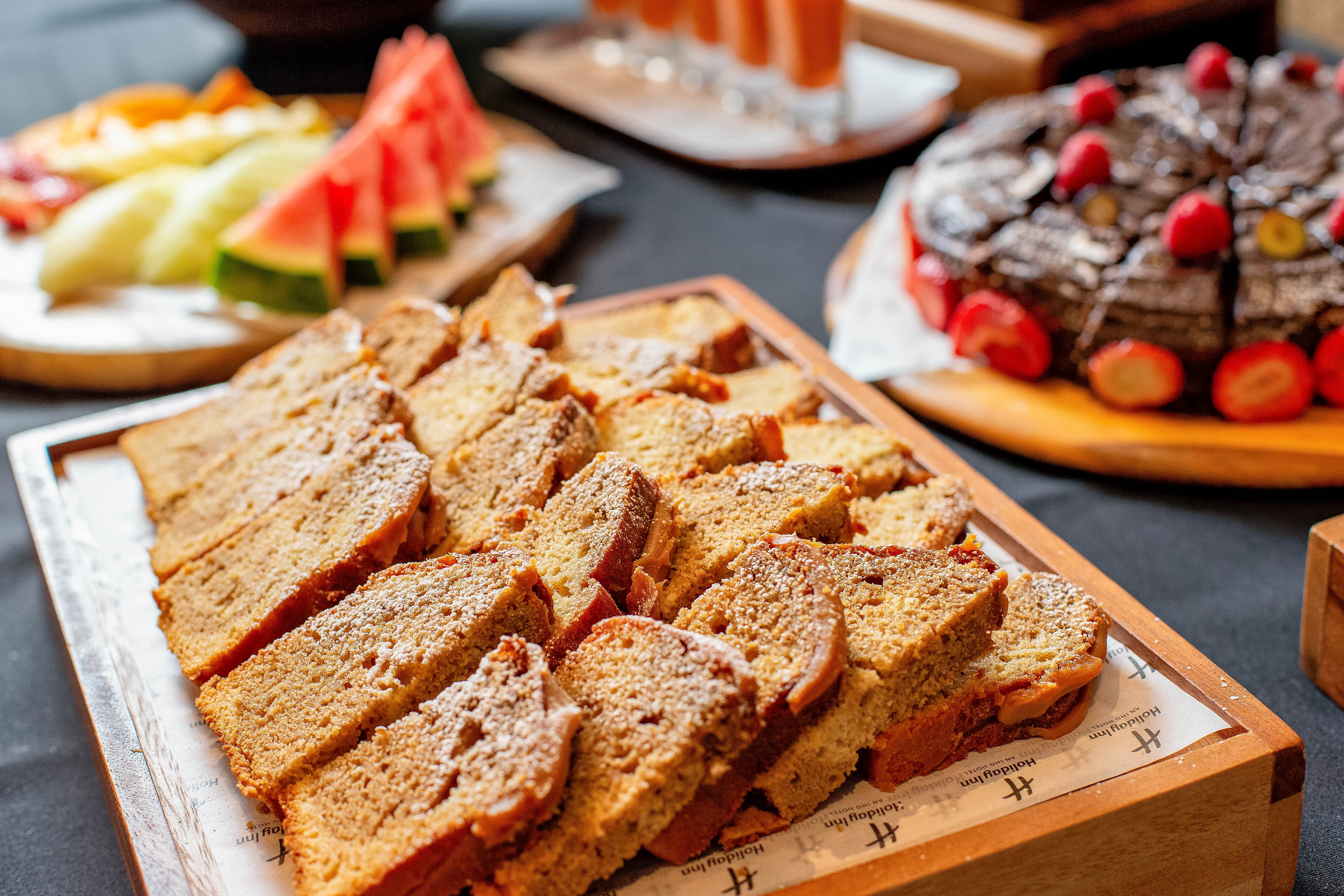 Buckingham Suite catering with sliced breads, cakes, and fruits for events in Kensington.