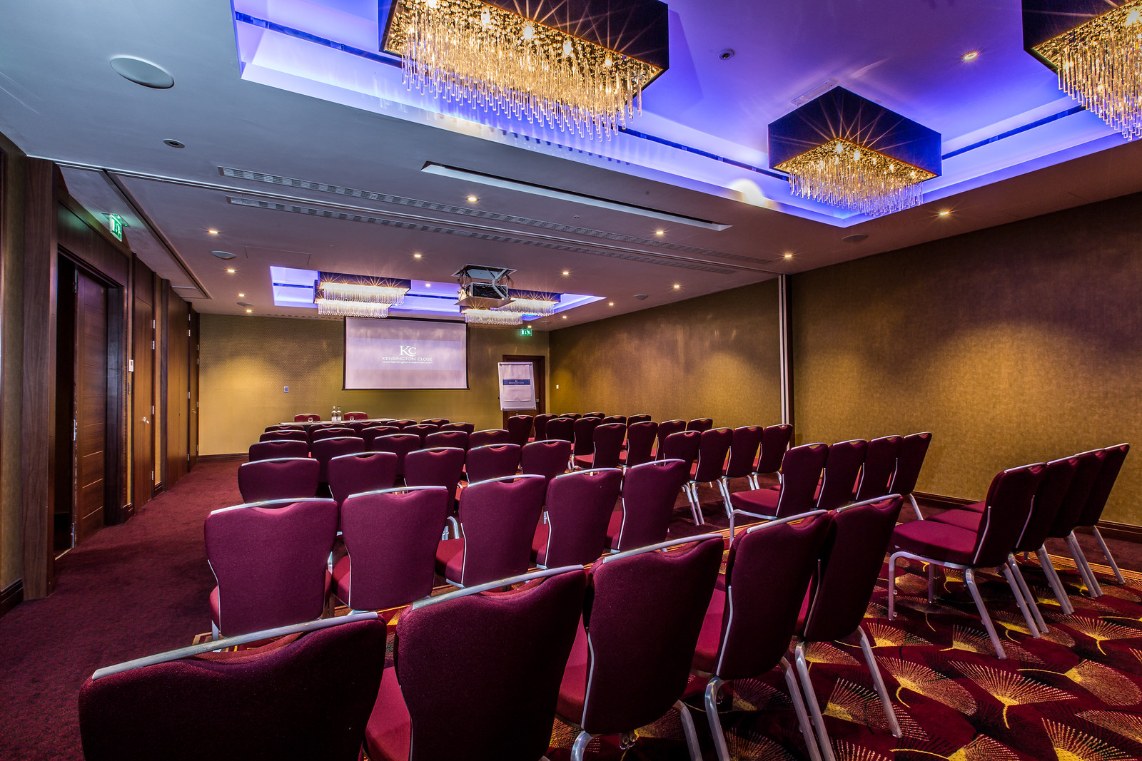 Windsor Suite at Holiday Inn Kensington: elegant meeting room with burgundy chairs for events.