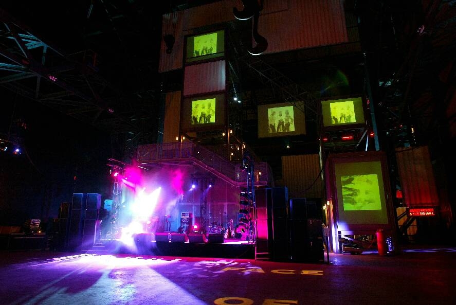 Dynamic event space with elevated stage, ideal for concerts and corporate events.