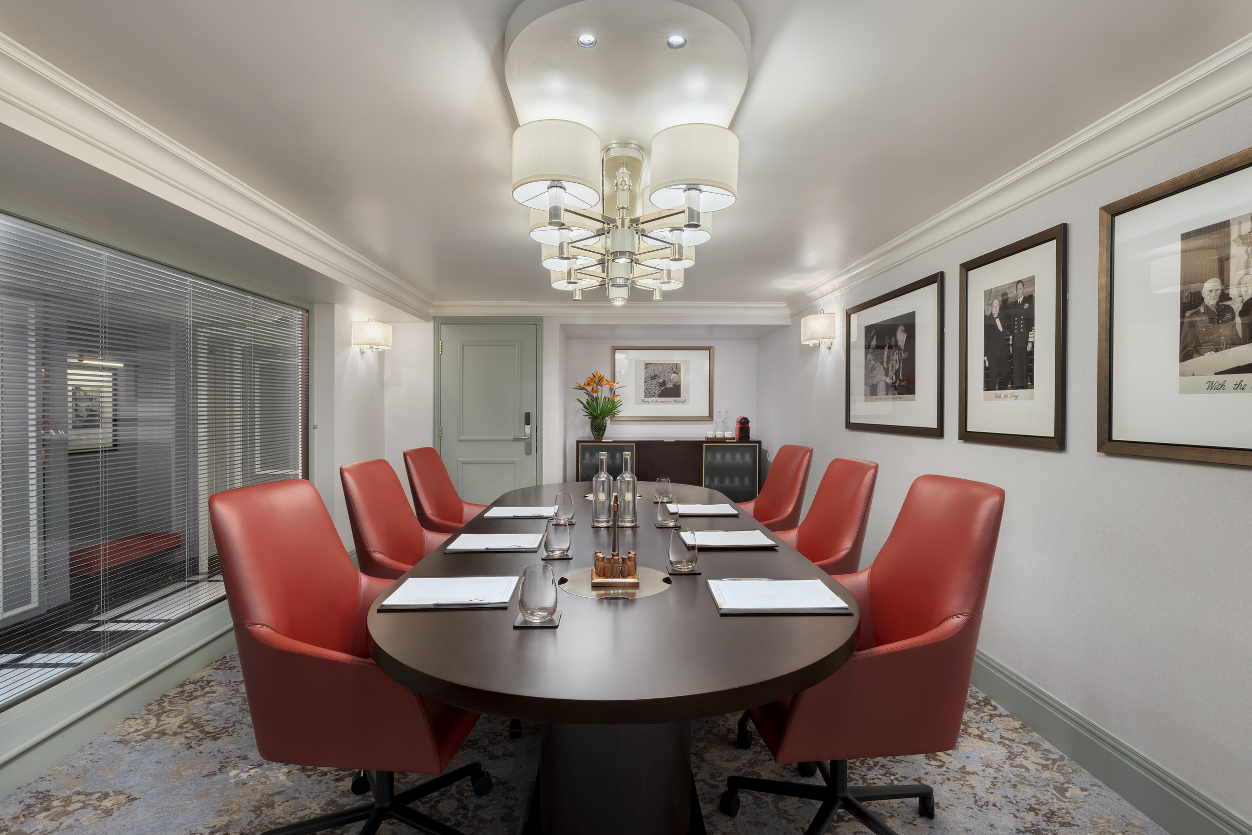 Boardroom 1 at Hyatt Regency London - The Churchill, featuring a sleek oval table for meetings.