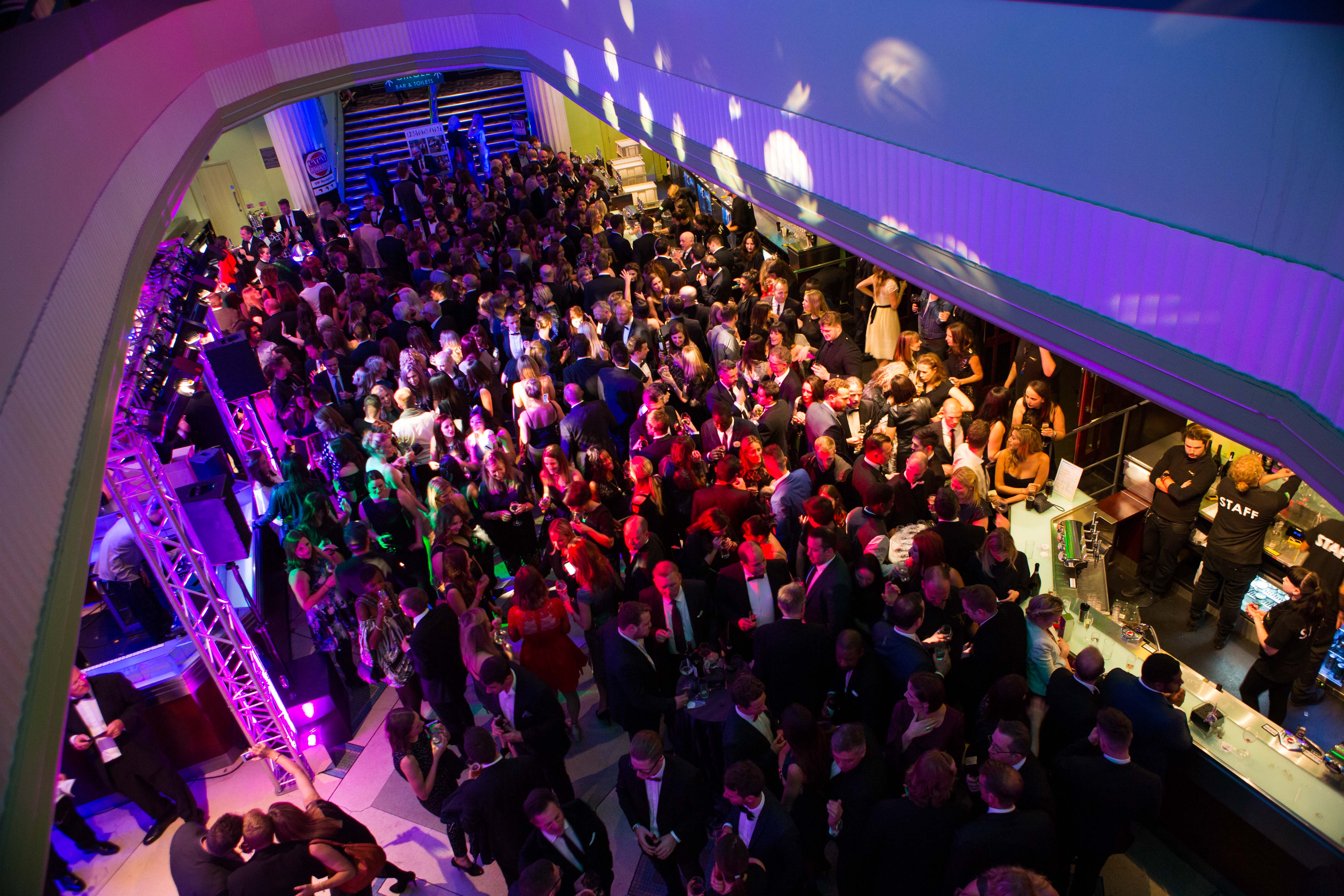 Vibrant networking event at Eventim Apollo, Hammersmith with colorful lighting and engaged attendees.