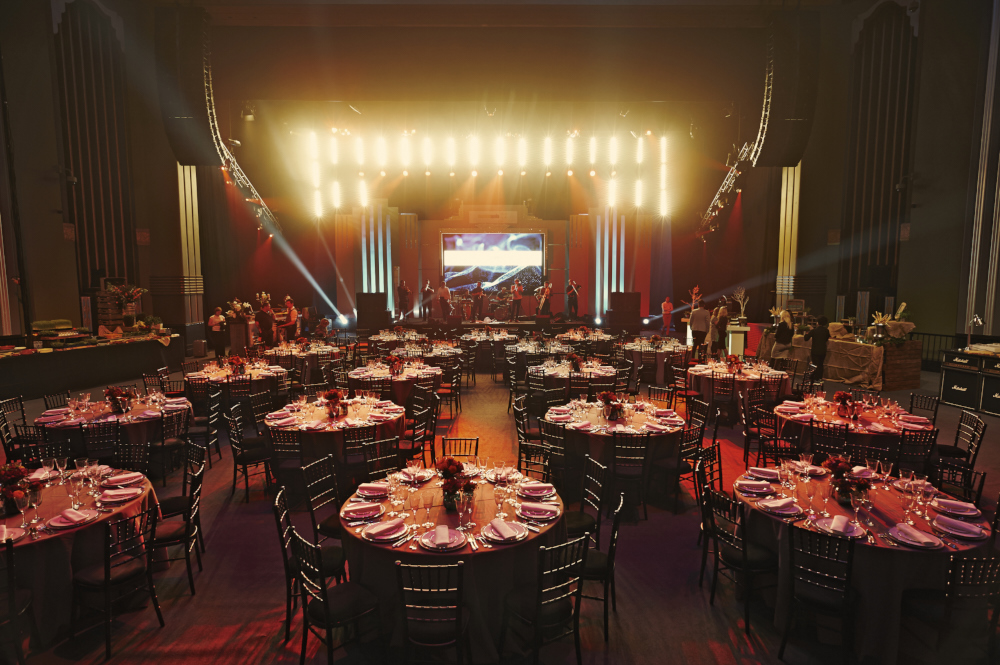 Whole Venue Eventim Apollo: elegant gala space with round tables and stage for corporate functions.