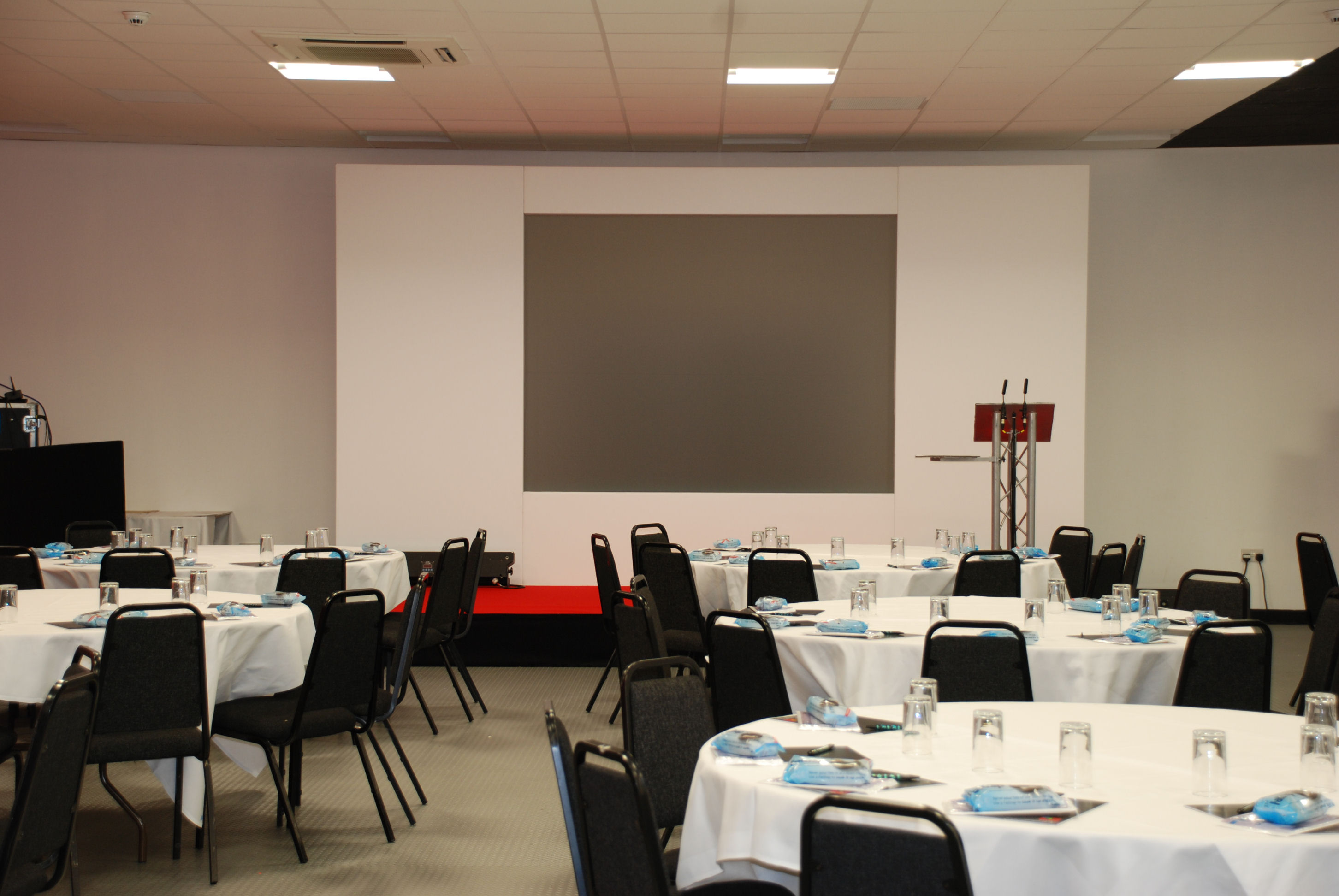 "Phoenix Rooms event space with round tables, ideal for conferences and formal gatherings."
