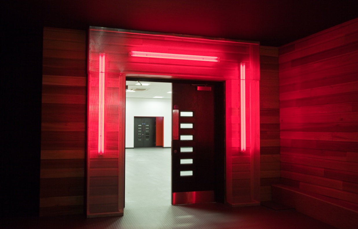 Phoenix Rooms entrance with bold red lighting, modern design for impressive events.