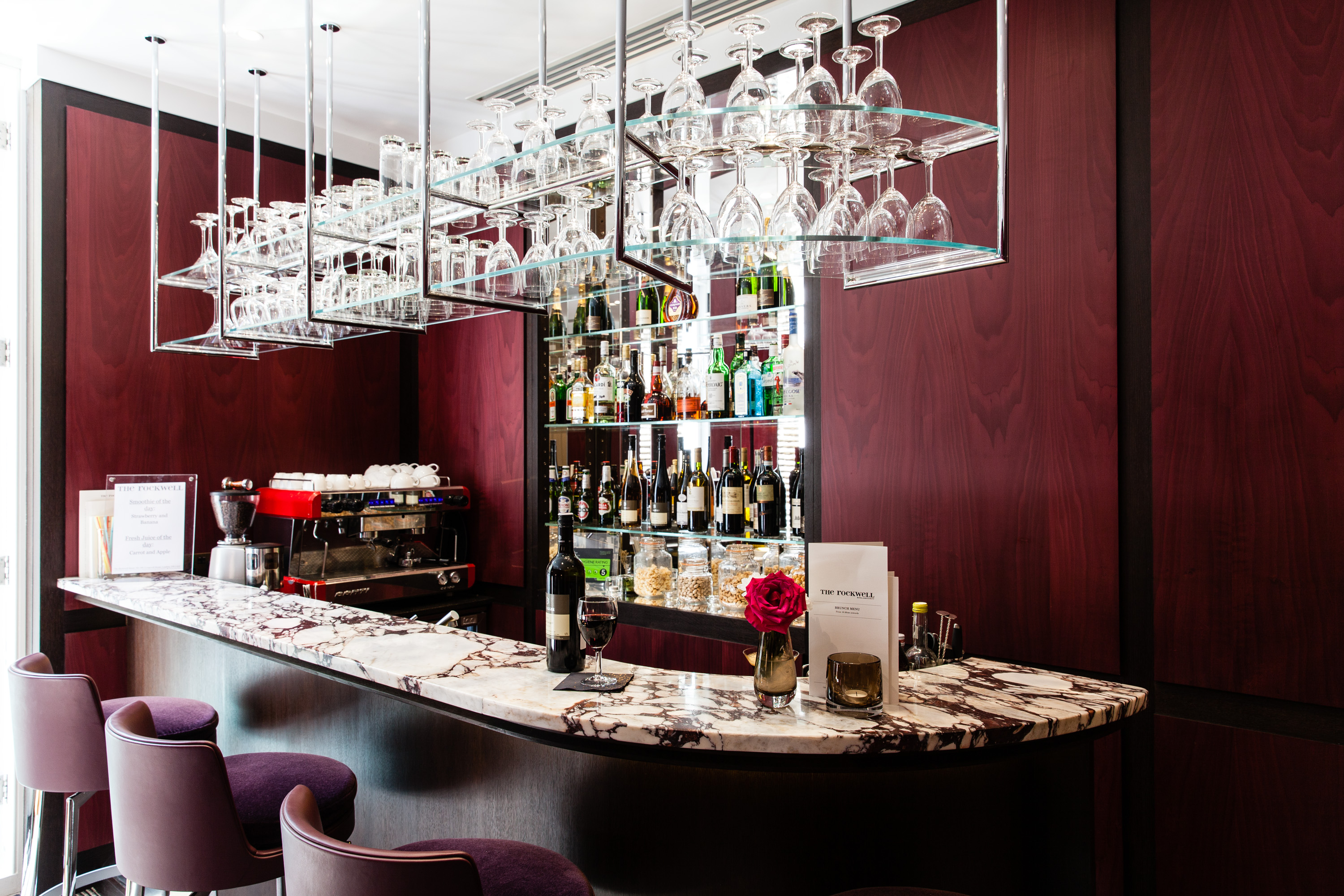 Modern bar area with marble countertop for networking events at The Rockwell.