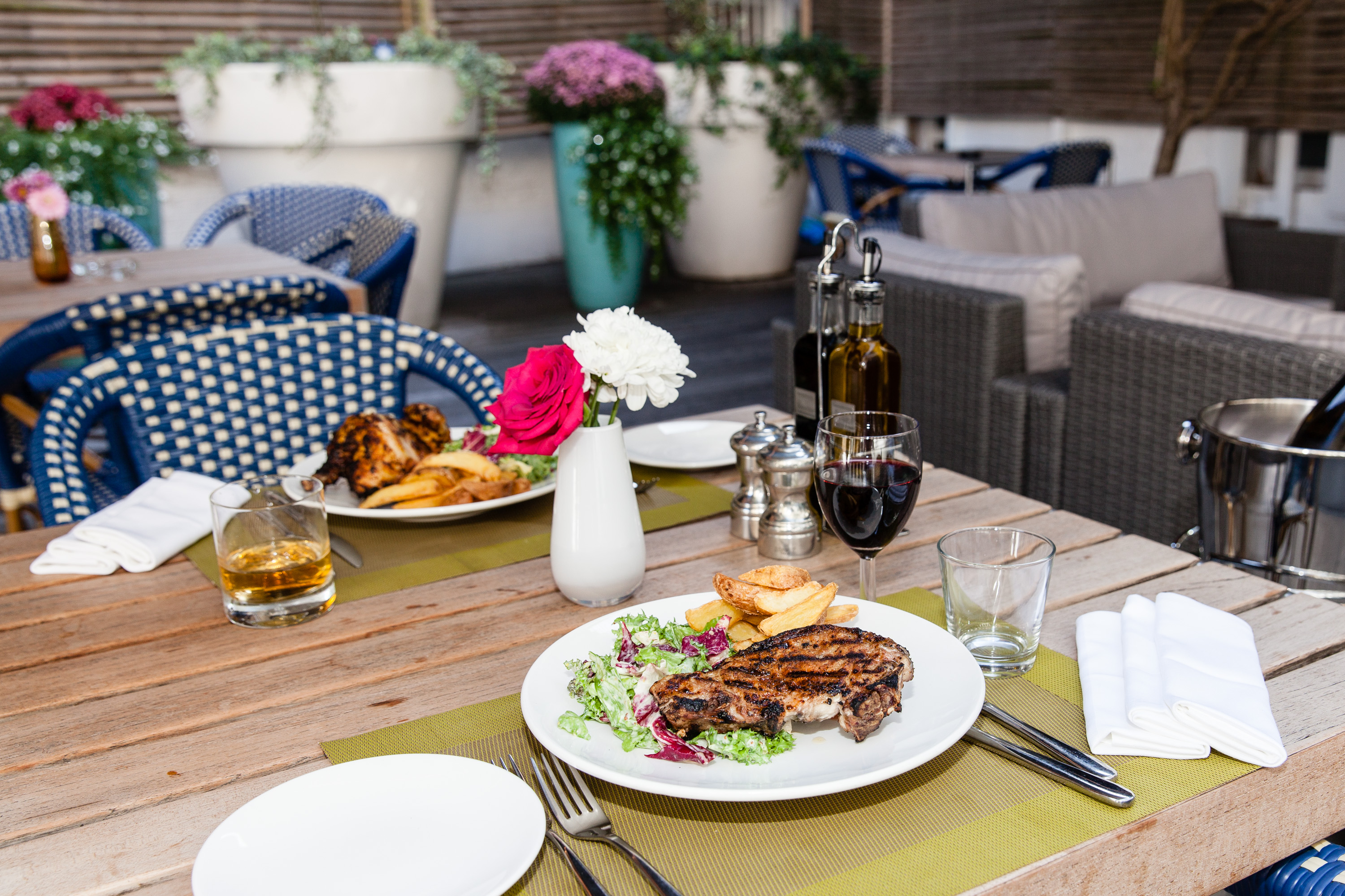 Outdoor dining table with steak, perfect for networking dinners and celebrations.