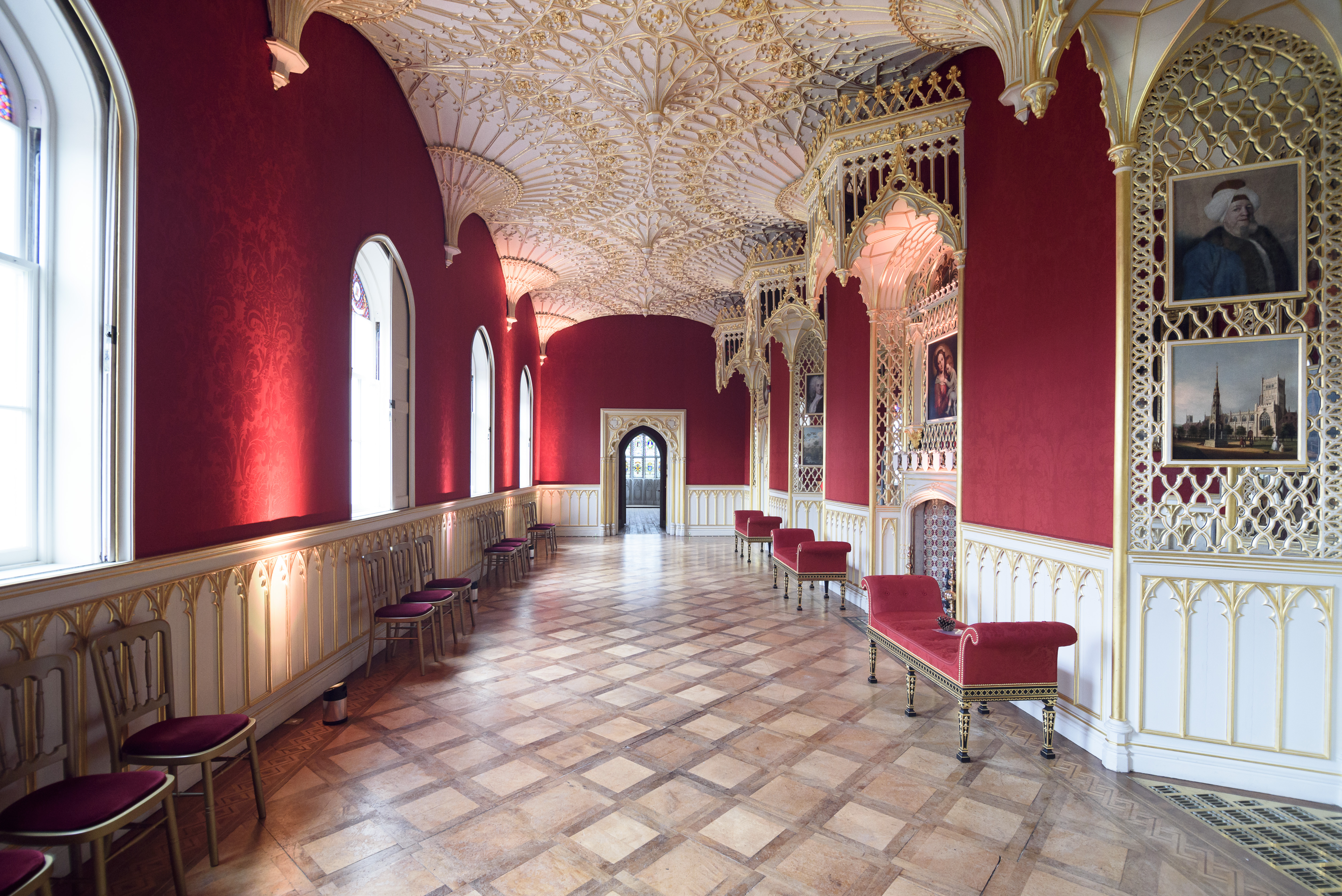 Ornate wedding venue with red walls and elegant seating at Strawberry Hill House.
