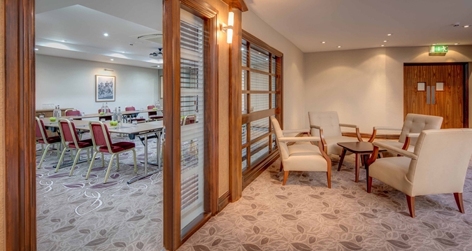 Byron suite at Hilton Cambridge: stylish meeting space with plush seating for events.