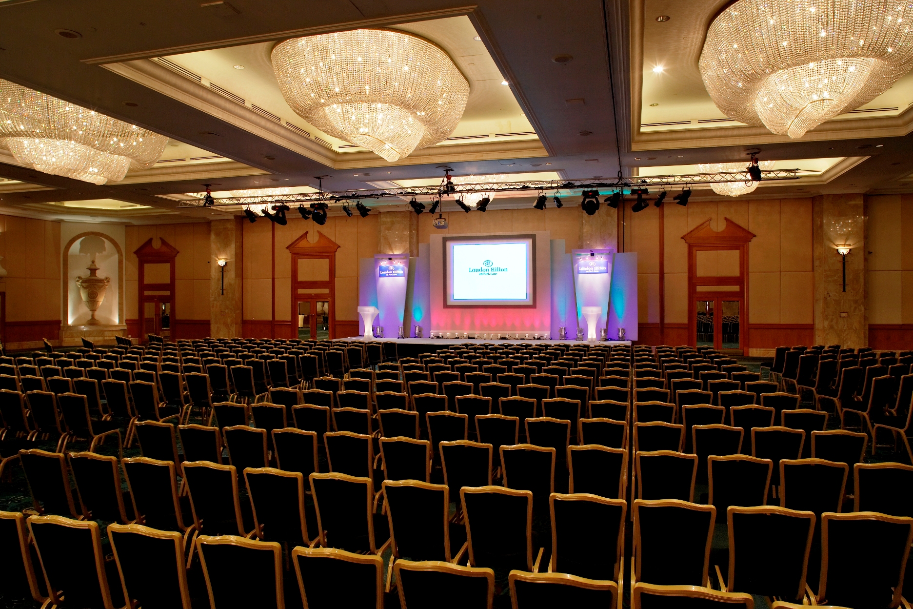 Grand Ballroom at London Hilton: spacious conference room for corporate events, elegant chandeliers.