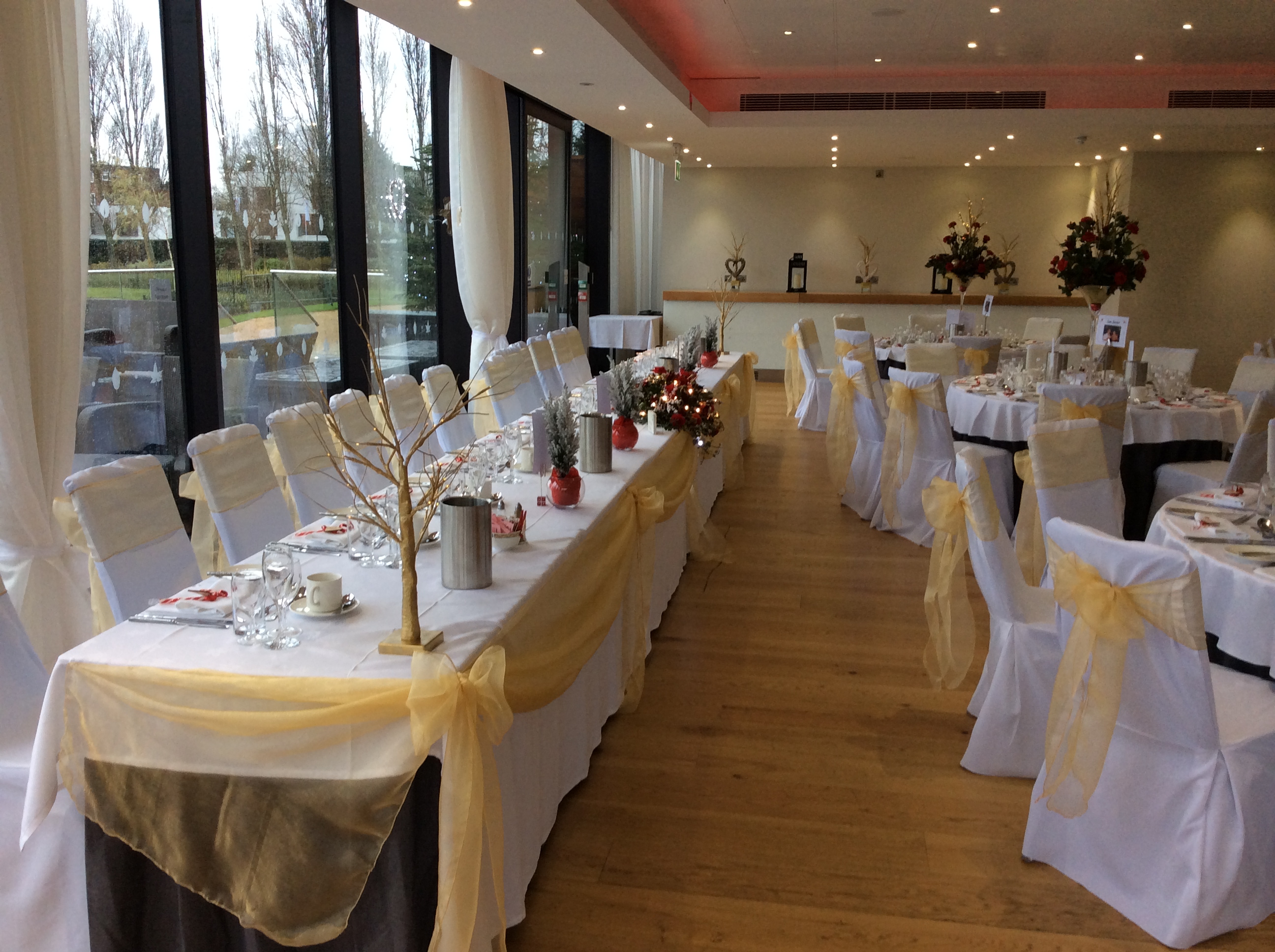 Thames View Suite at The Lensbury, elegant wedding venue with gold accents and floral decor.