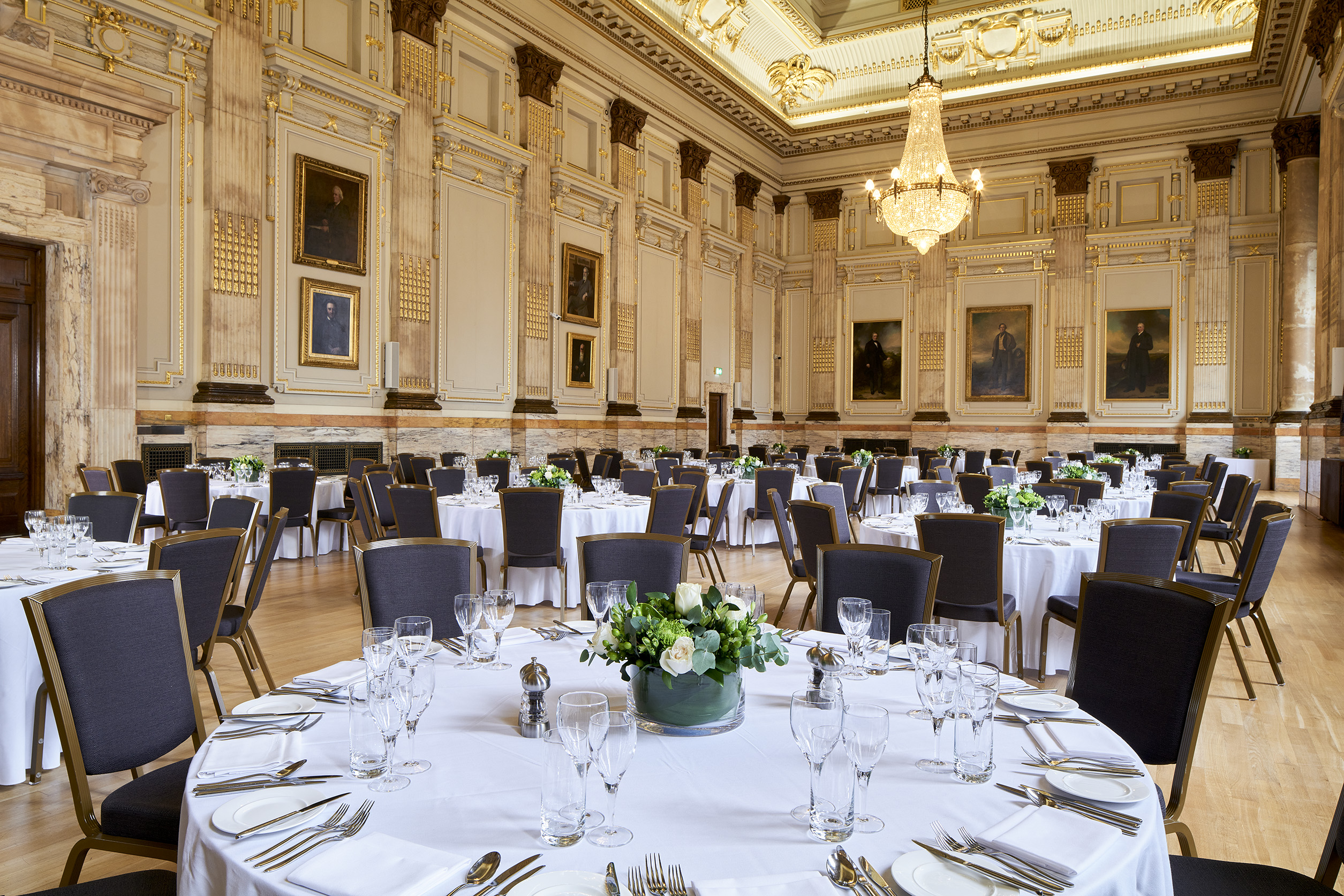 Elegant banquet hall with round tables, ideal for corporate events and upscale celebrations.