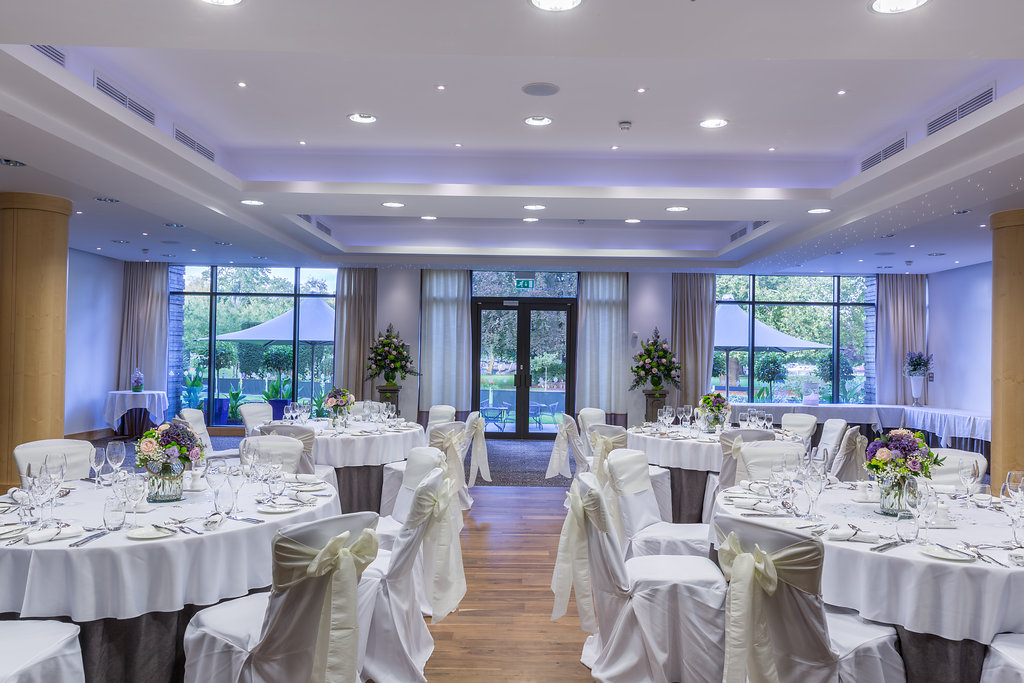 Wimbledon Room at The Lensbury, elegant wedding venue with floral centerpieces.