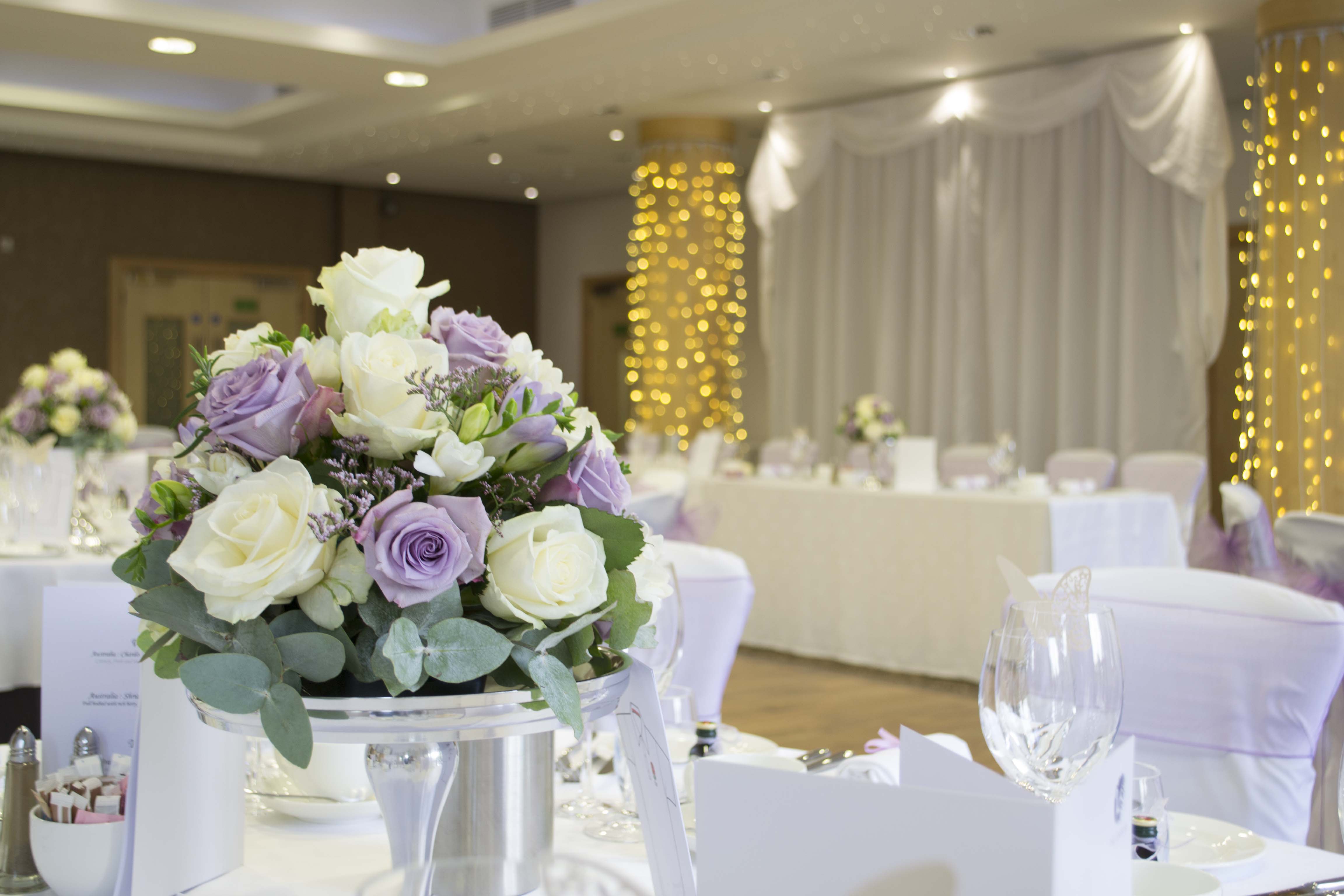 Elegant Wimbledon Room at The Lensbury with floral centerpieces for weddings and events.