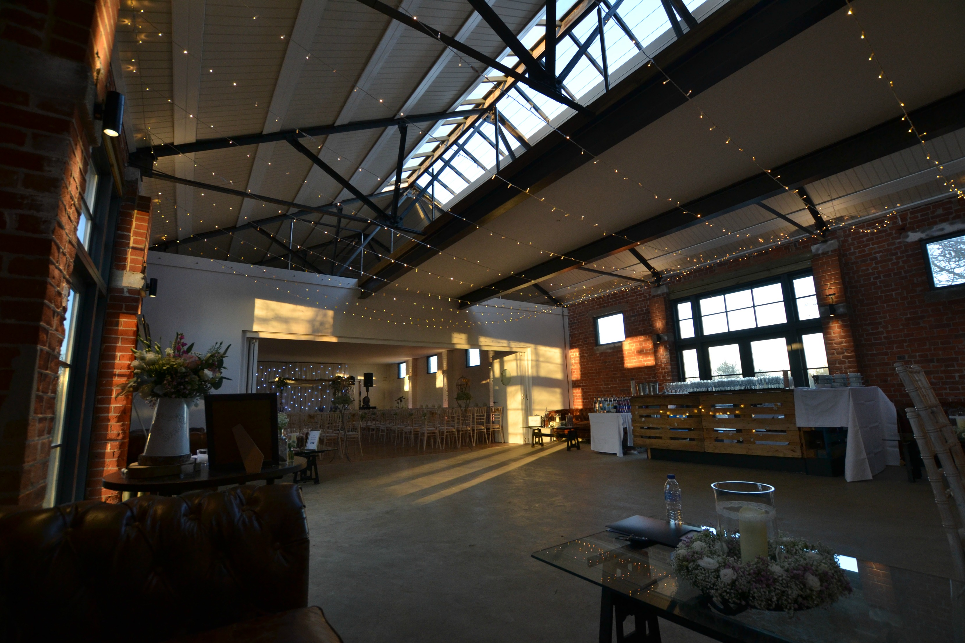 The Bomb Factory event space with exposed brick and fairy lights, ideal for gatherings.