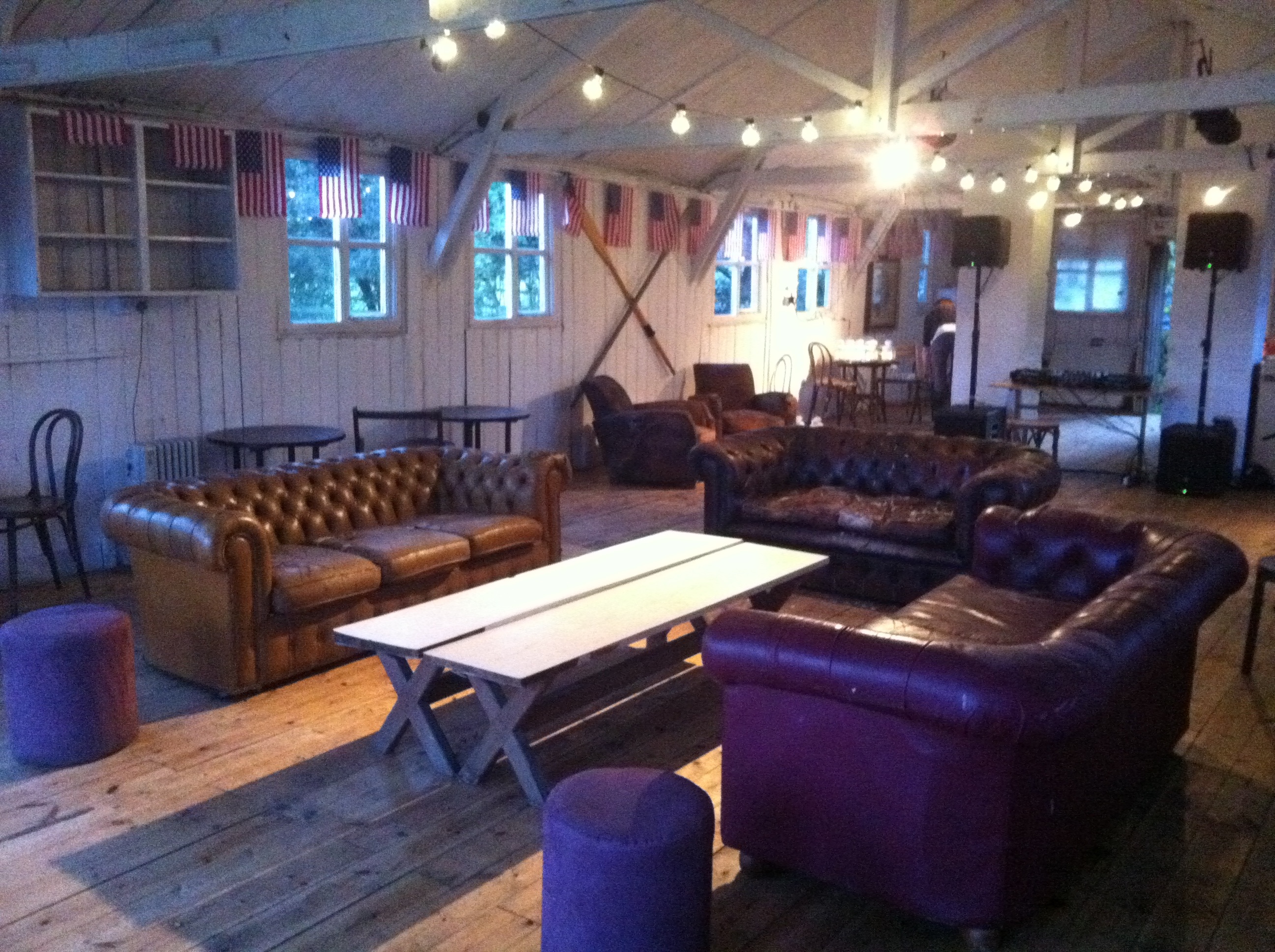 Cozy rustic event space with leather seating on Osea Island for informal gatherings.