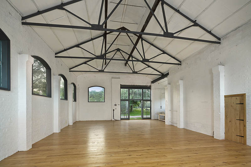 Spacious event venue with high ceilings on Osea Island, perfect for meetings and gatherings.