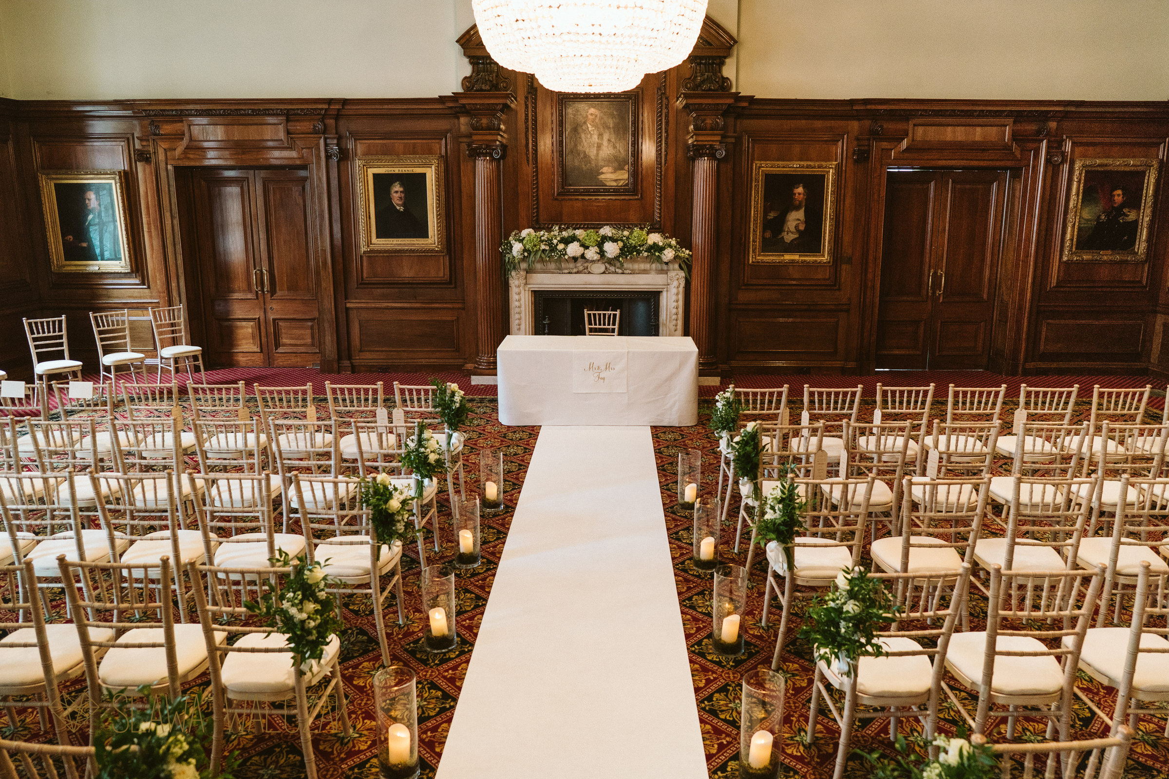 Elegant Smeaton Room wedding venue with wooden paneling and floral decor.