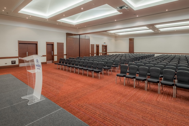 Windsor Suite at Hilton Reading, spacious conference room with black chairs for events.