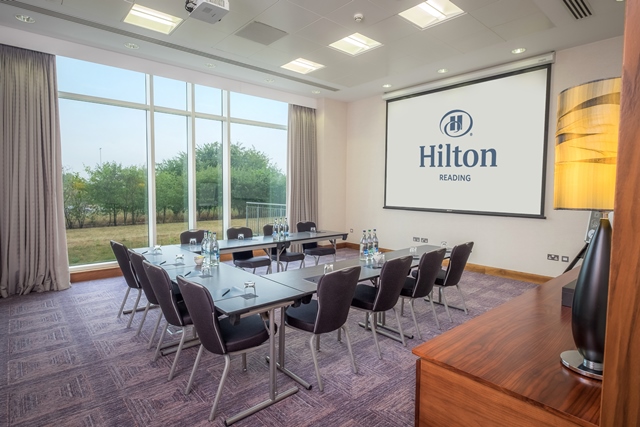 Kennet and Sutton Suite at Hilton Reading, modern meeting room with large screen.