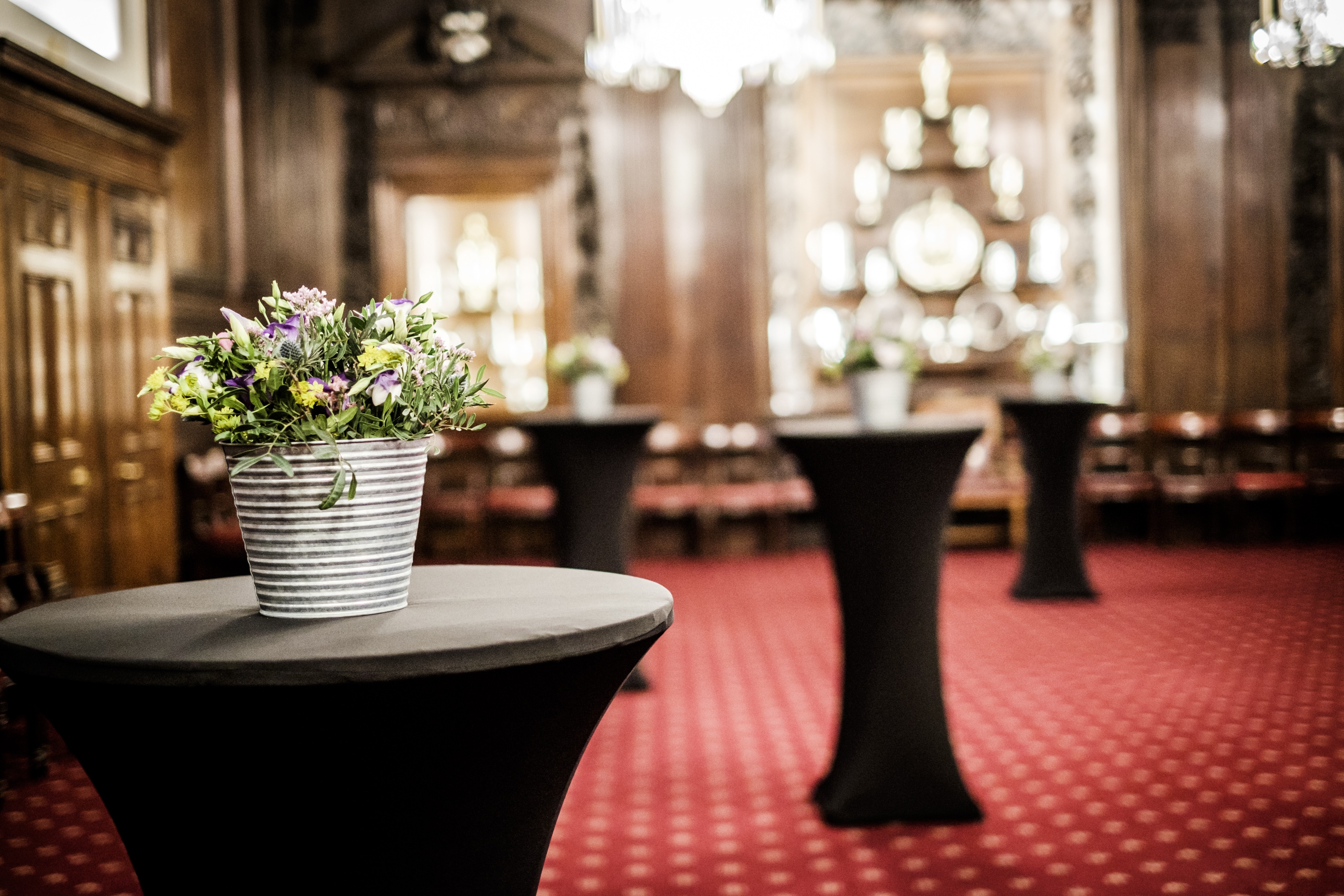 Elegant Livery Hall with high-top tables, ideal for networking events and cocktail receptions.