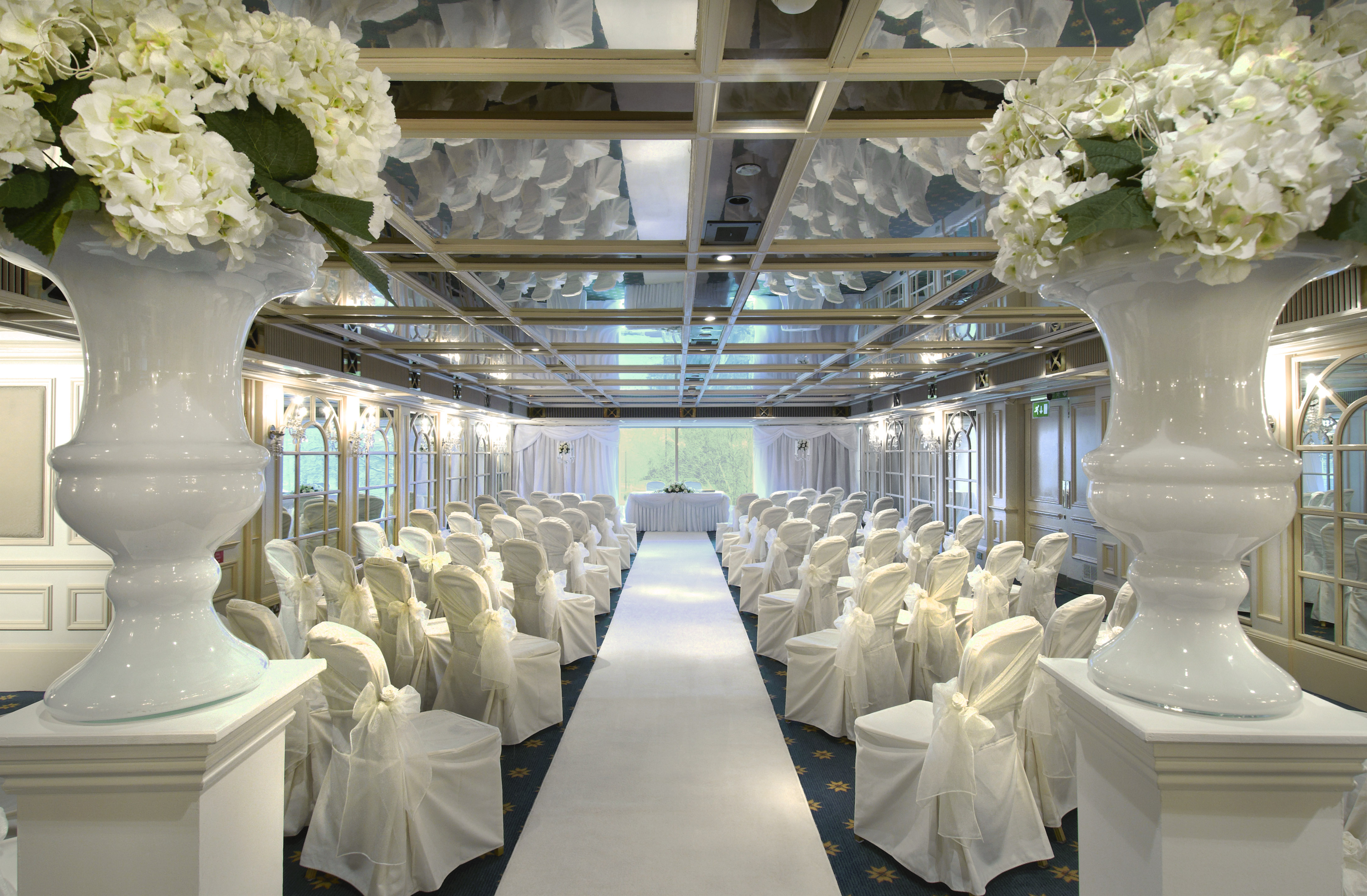 Crystal Palace event space with elegant chairs and floral arrangements for weddings.