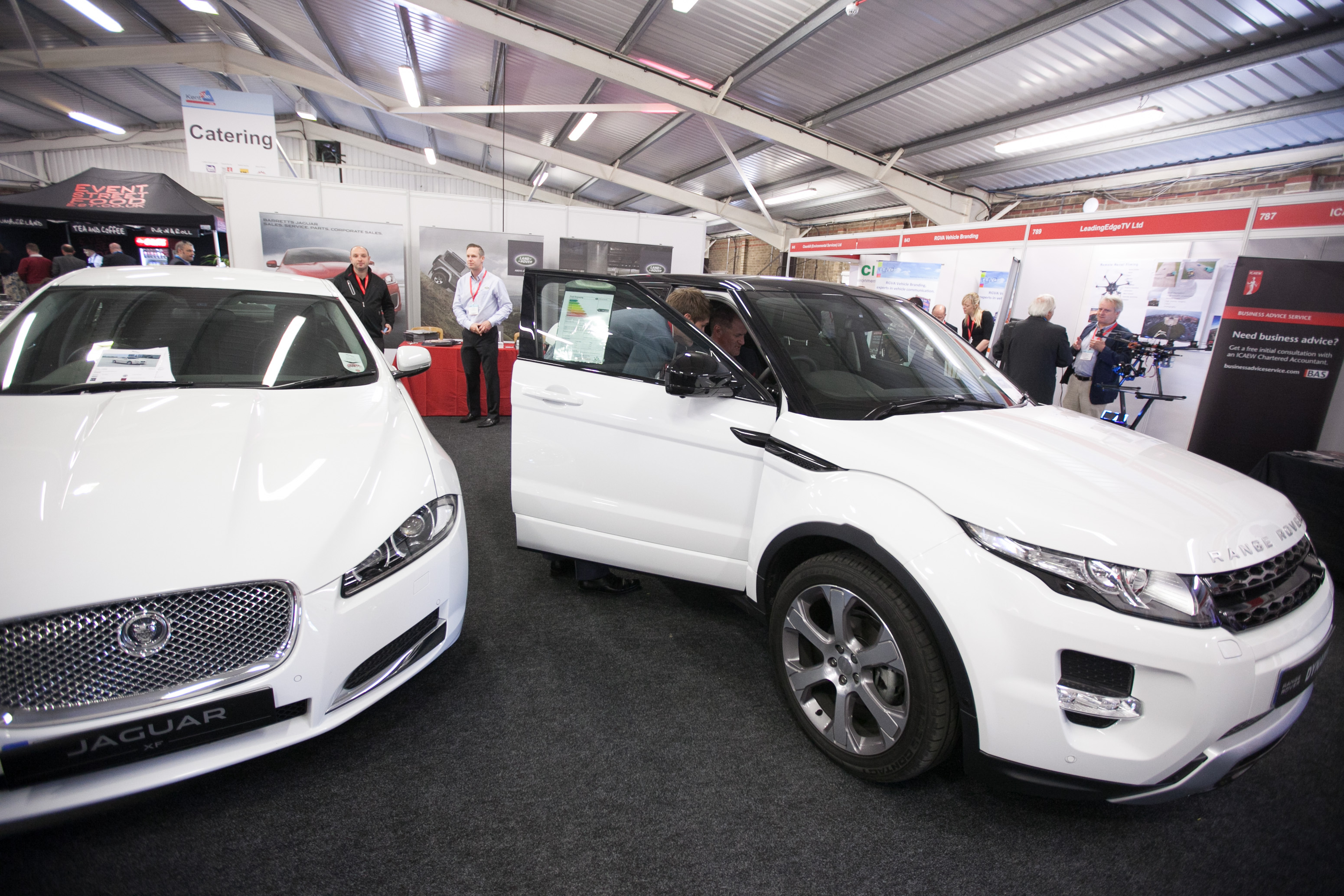 John Hendry Pavilion with luxury cars at an automotive trade show event.