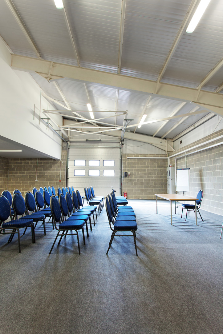 Cornwallis Room at Kent Event Centre, featuring blue chairs for meetings and industrial decor.