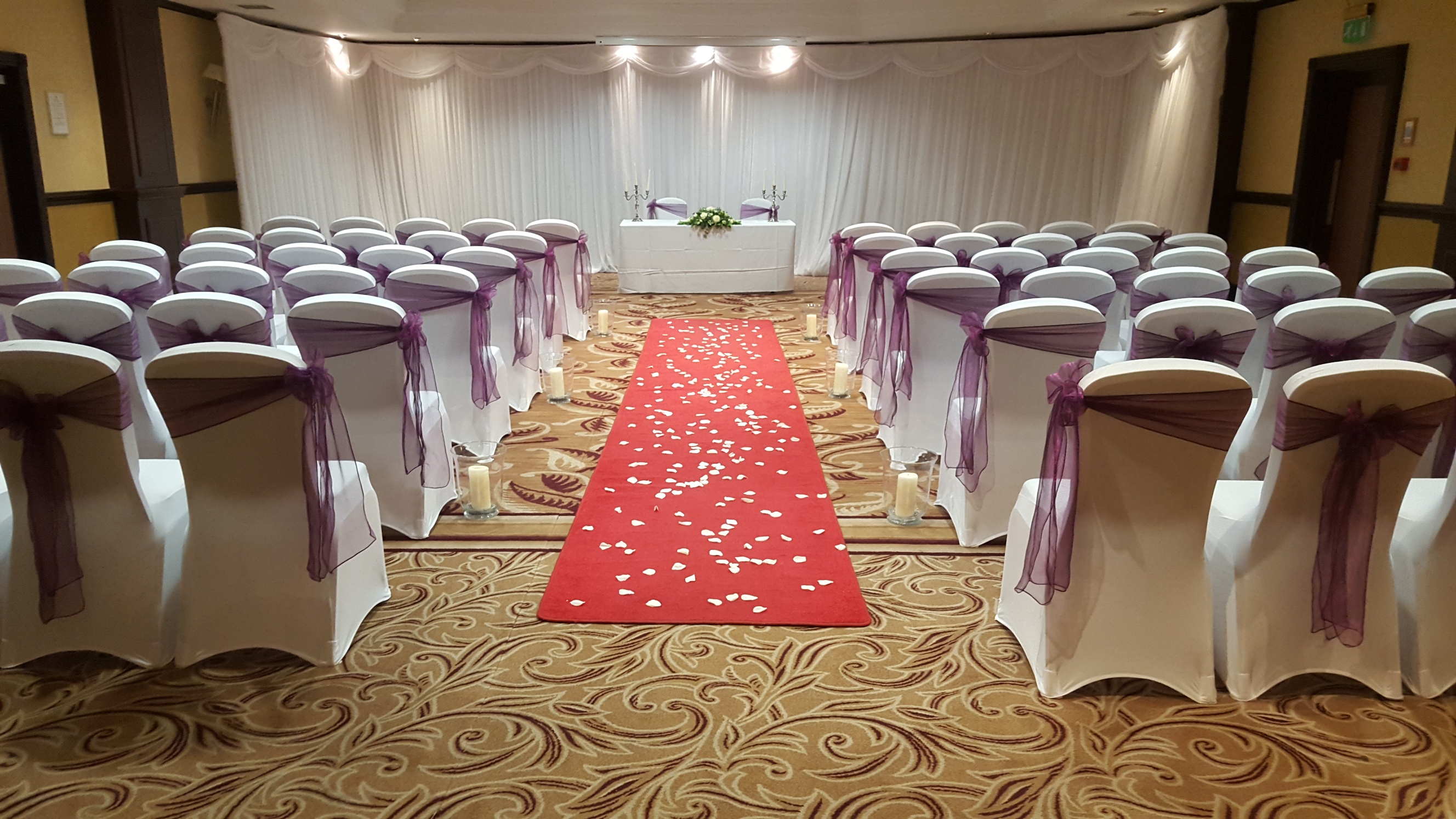 Lansdowne Suite at Grosvenor Hotel, elegant wedding venue with purple sashes and red carpet.