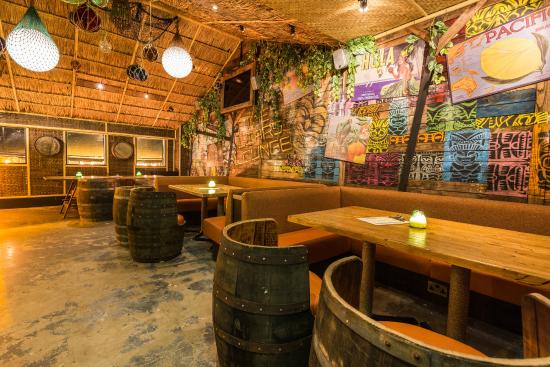 Tropical-themed Liars Lounge with rustic decor, perfect for casual meetings and events.