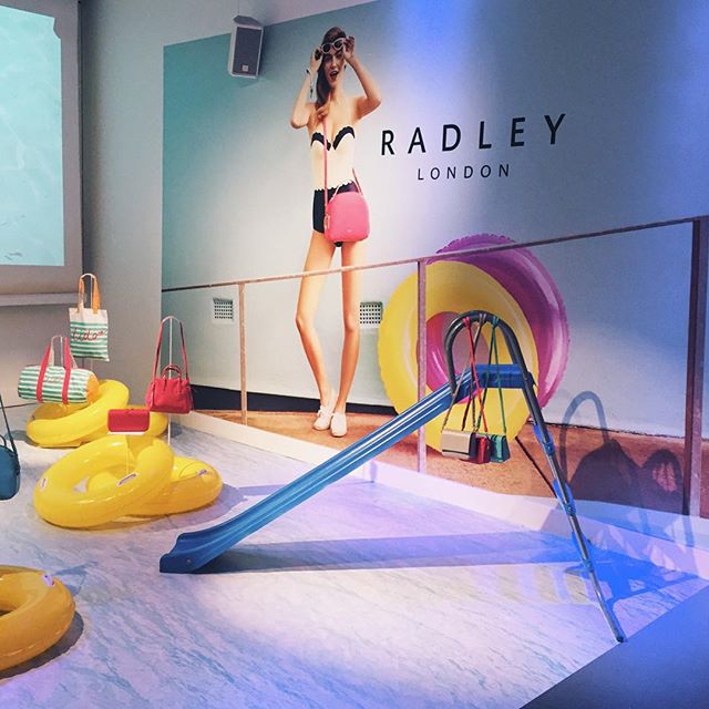 Vibrant event space for Radley London showcasing summer-themed fashion products.