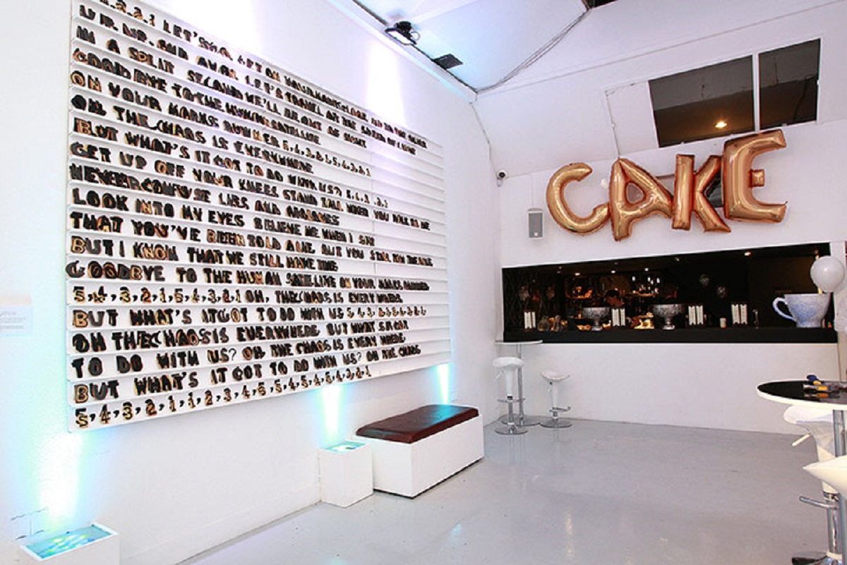 Vibrant event space with "CAKE" decor, perfect for celebrations and networking events.