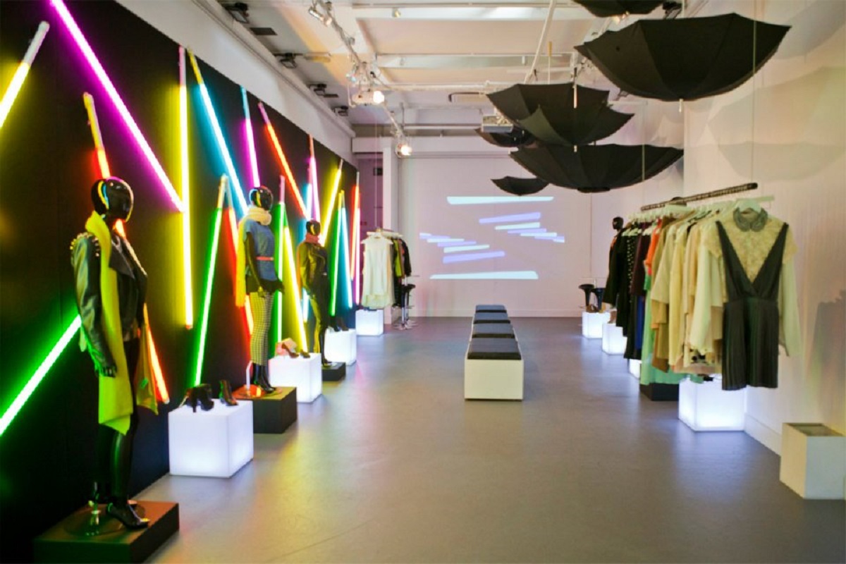 Vibrant fashion showcase event space with neon lighting and stylish displays.
