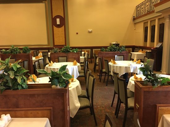 Private dining room with elegant round tables for intimate gatherings at Grand Palace Seafood.