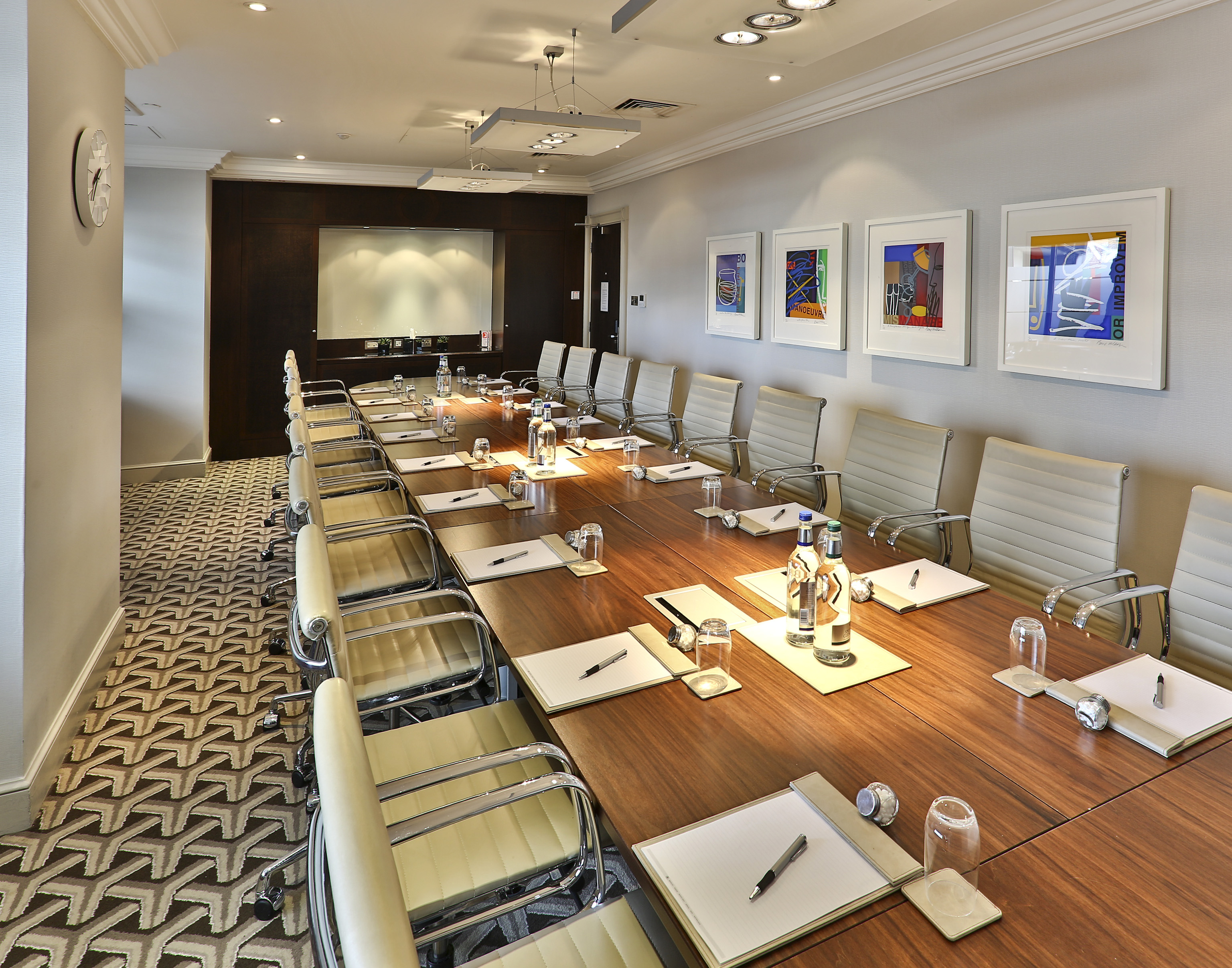 Marlborough Suite conference room at London Hilton, featuring a polished table and modern chairs.