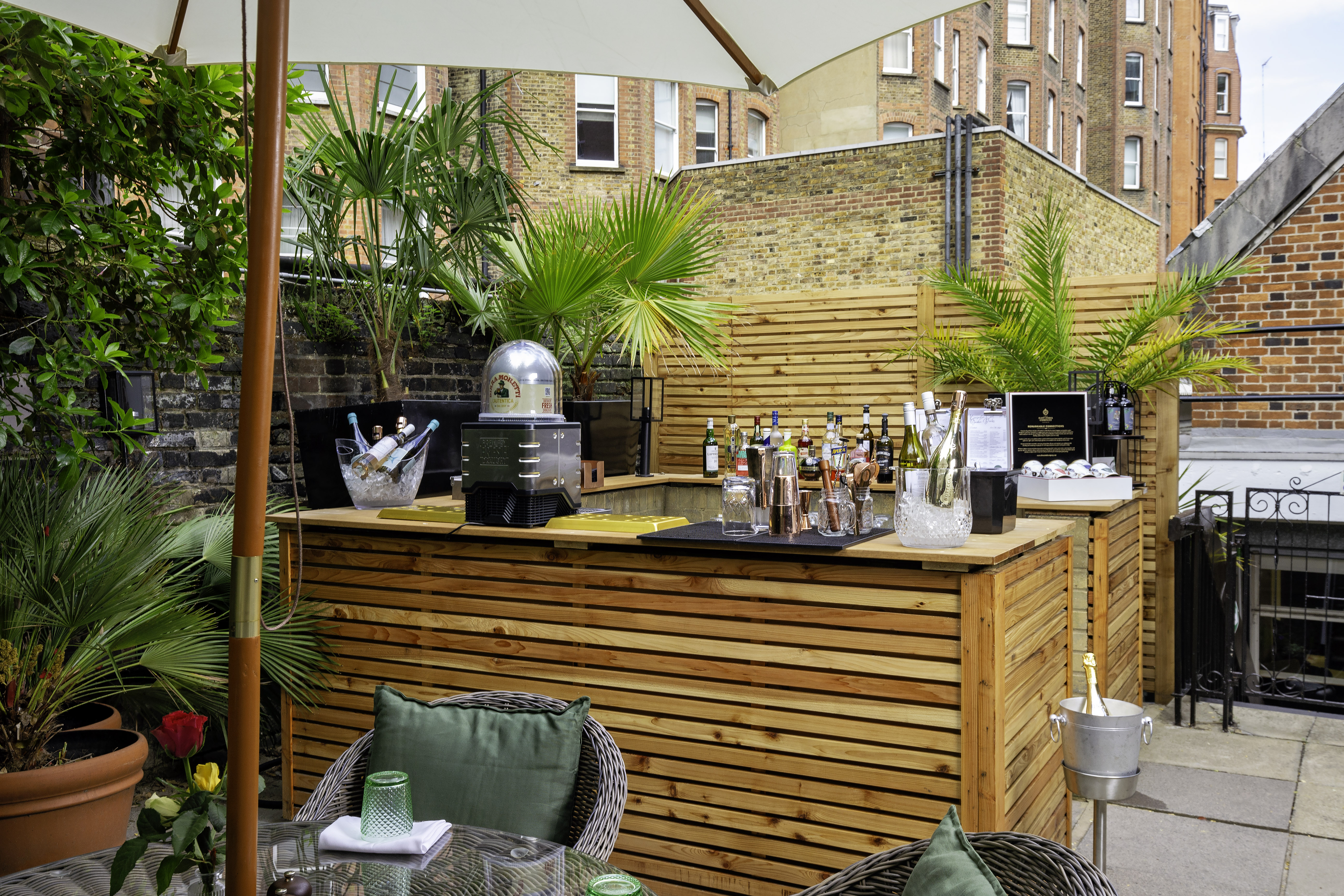 Stylish outdoor bar at Holiday Inn Kensington, perfect for summer networking events.