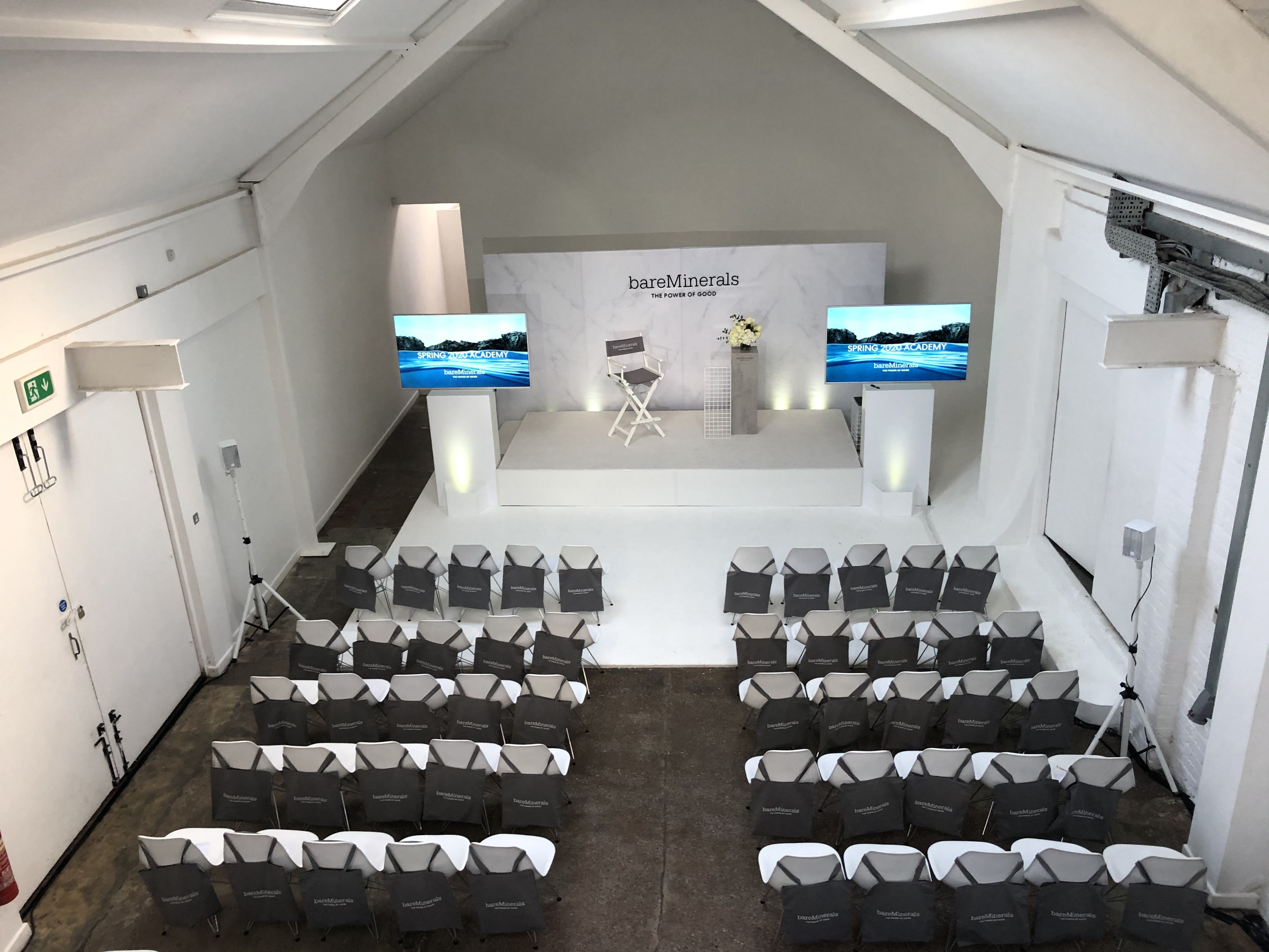 Event space at FiveFour Studios with minimalist stage, ideal for conferences and presentations.