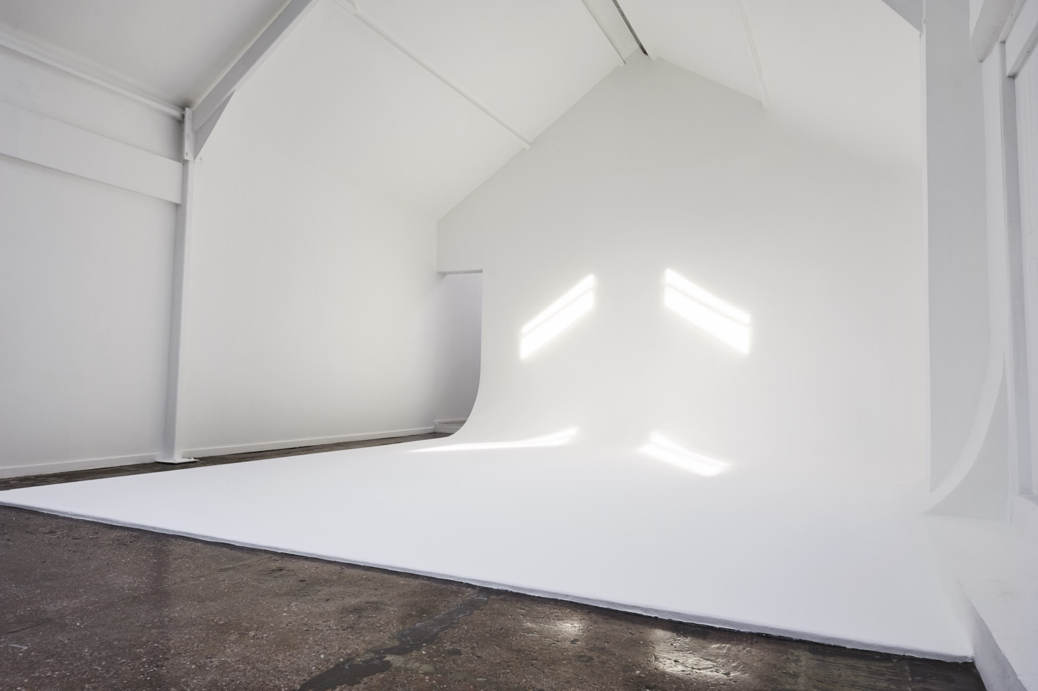 Minimalist event space with natural light for creative meetings and product launches.