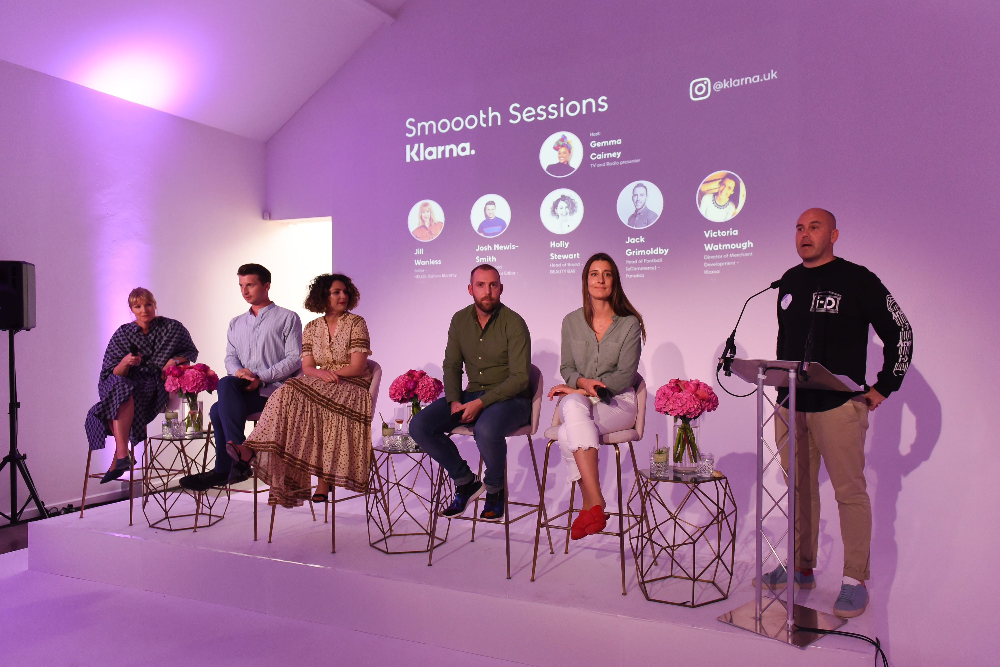 Panel discussion setup with diverse speakers, elegant decor for networking event.