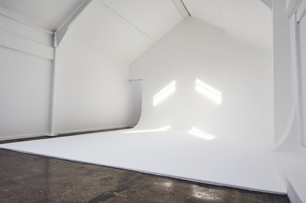 Minimalist event space with natural light for meetings and workshops at FiveFour Studios.